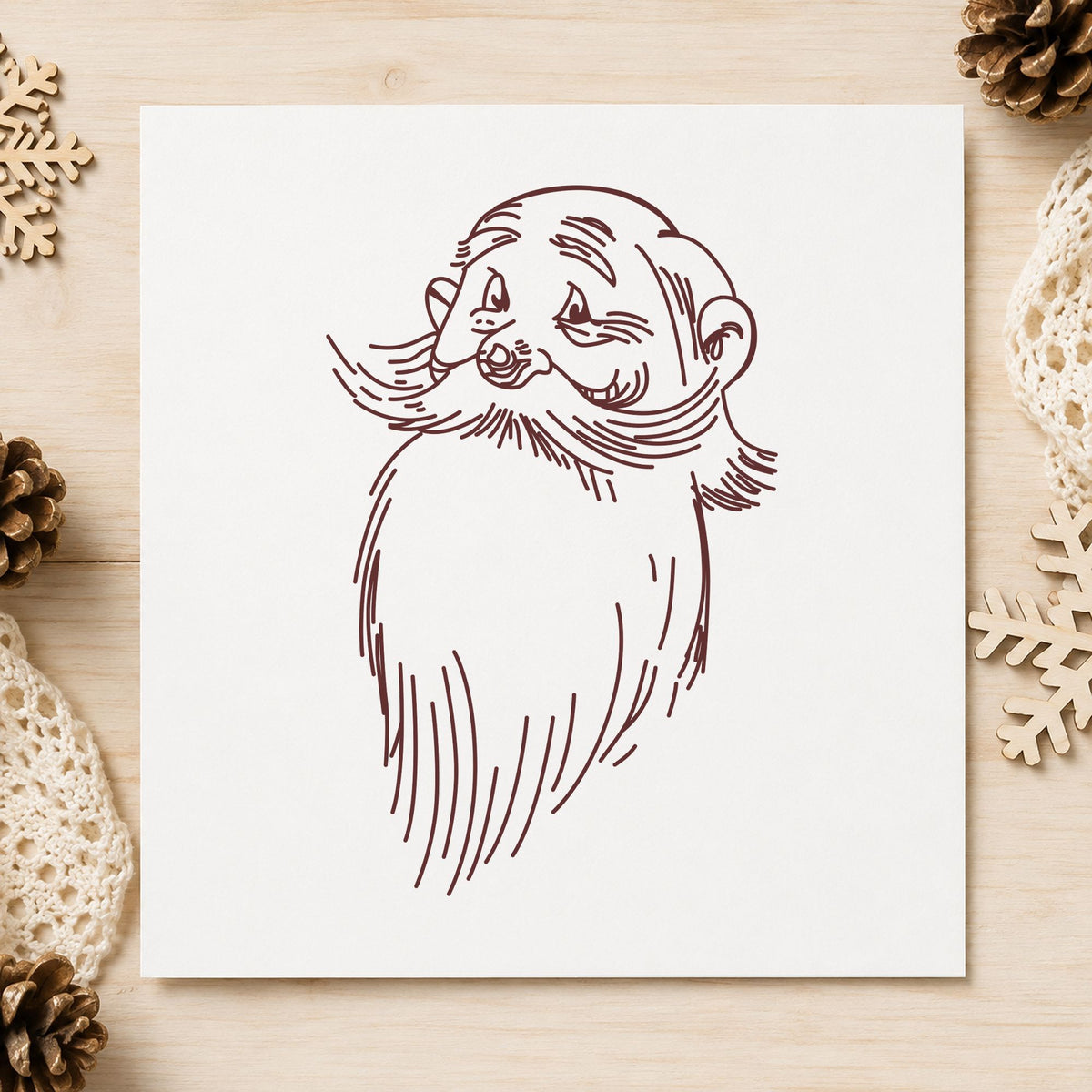Santa Claus Face Rubber Stamp impression in brown ink on white paper in a styled craft setting.