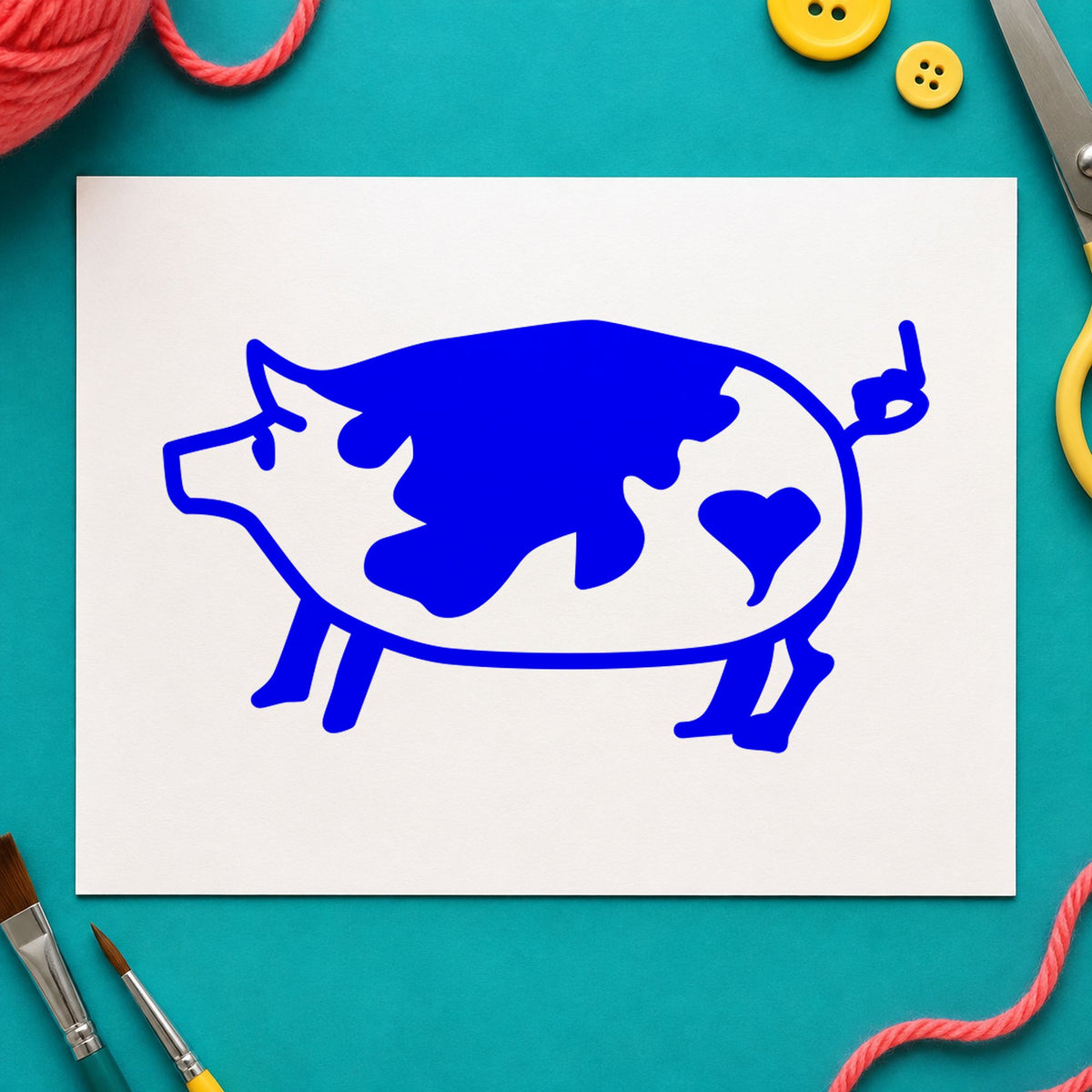 Blue farm animal stamp impression featuring the spotted pig with heart design on white paper.