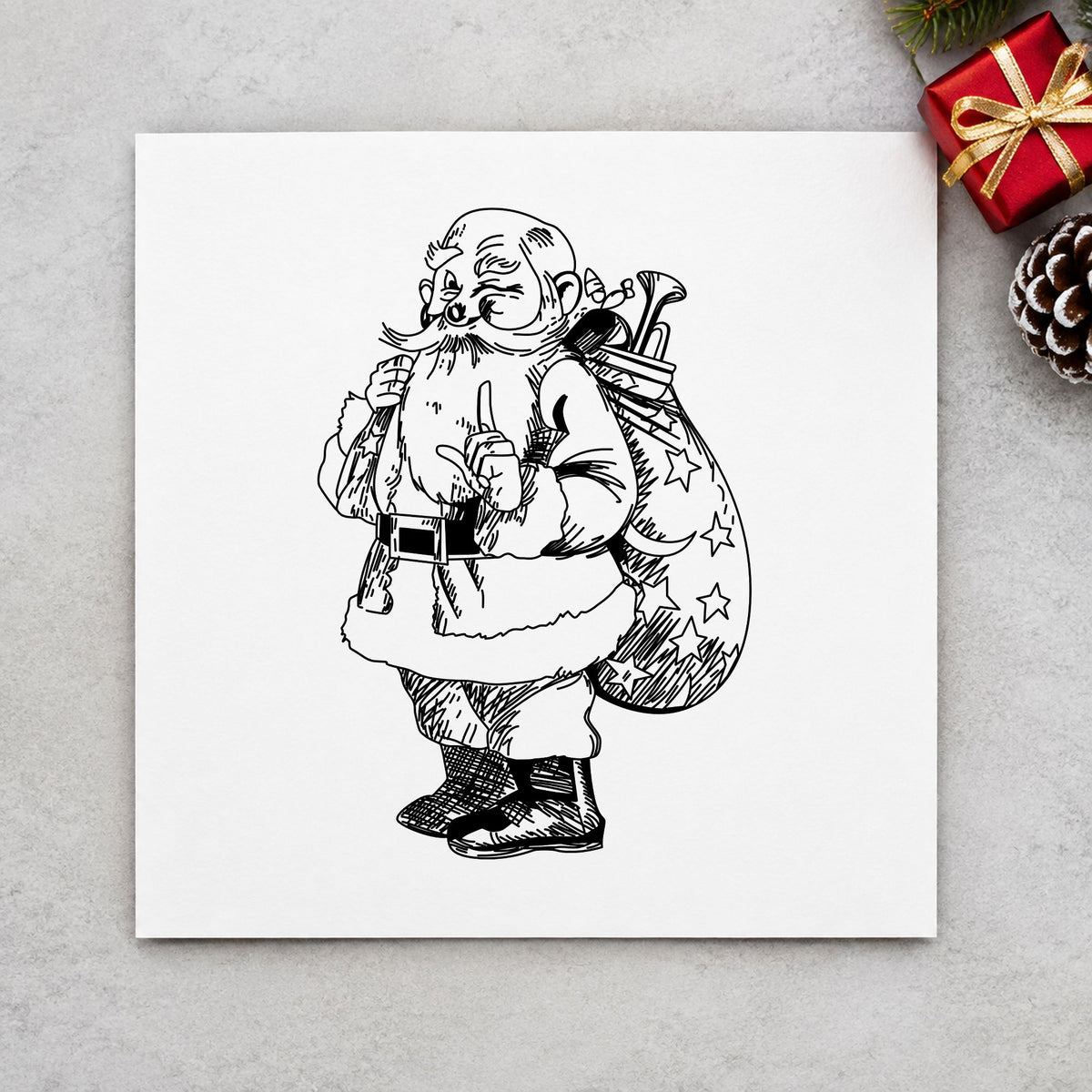 Black impression from a santa claus stamp, featuring the santa with gift sack design on white paper.
