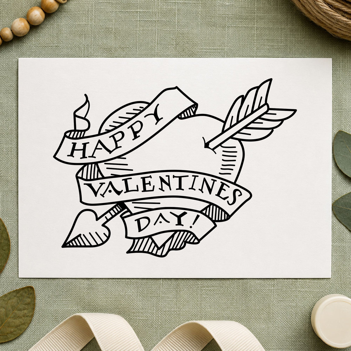 Valentine Heart with Arrow Rubber Stamp impression in black ink on white paper in a styled craft setting.