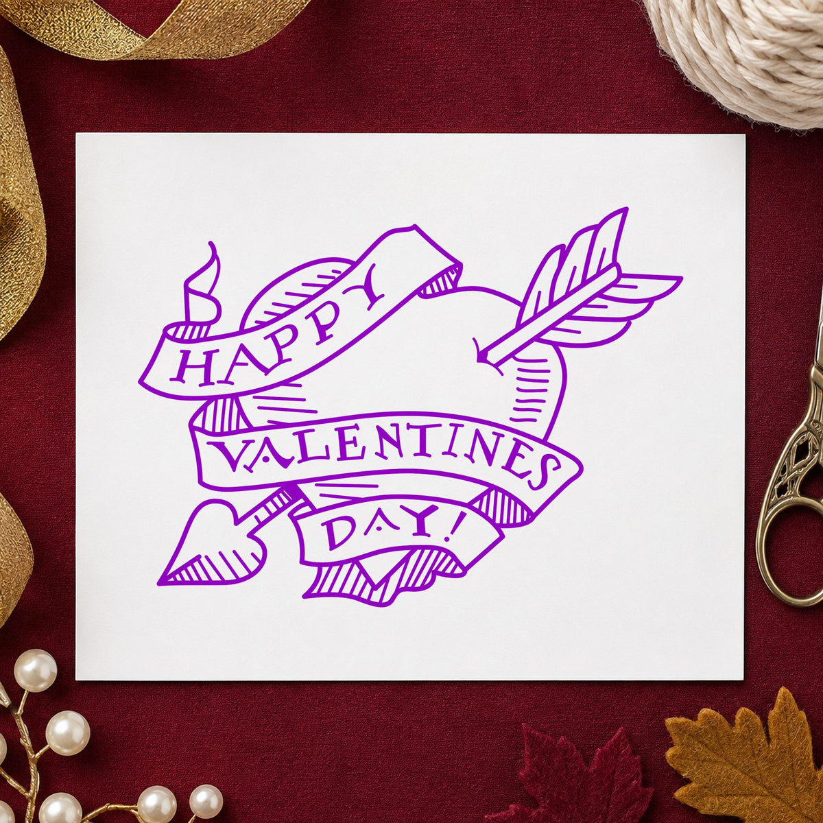 Valentine Heart with Arrow Rubber Stamp impression in purple ink on white paper in a styled craft setting.