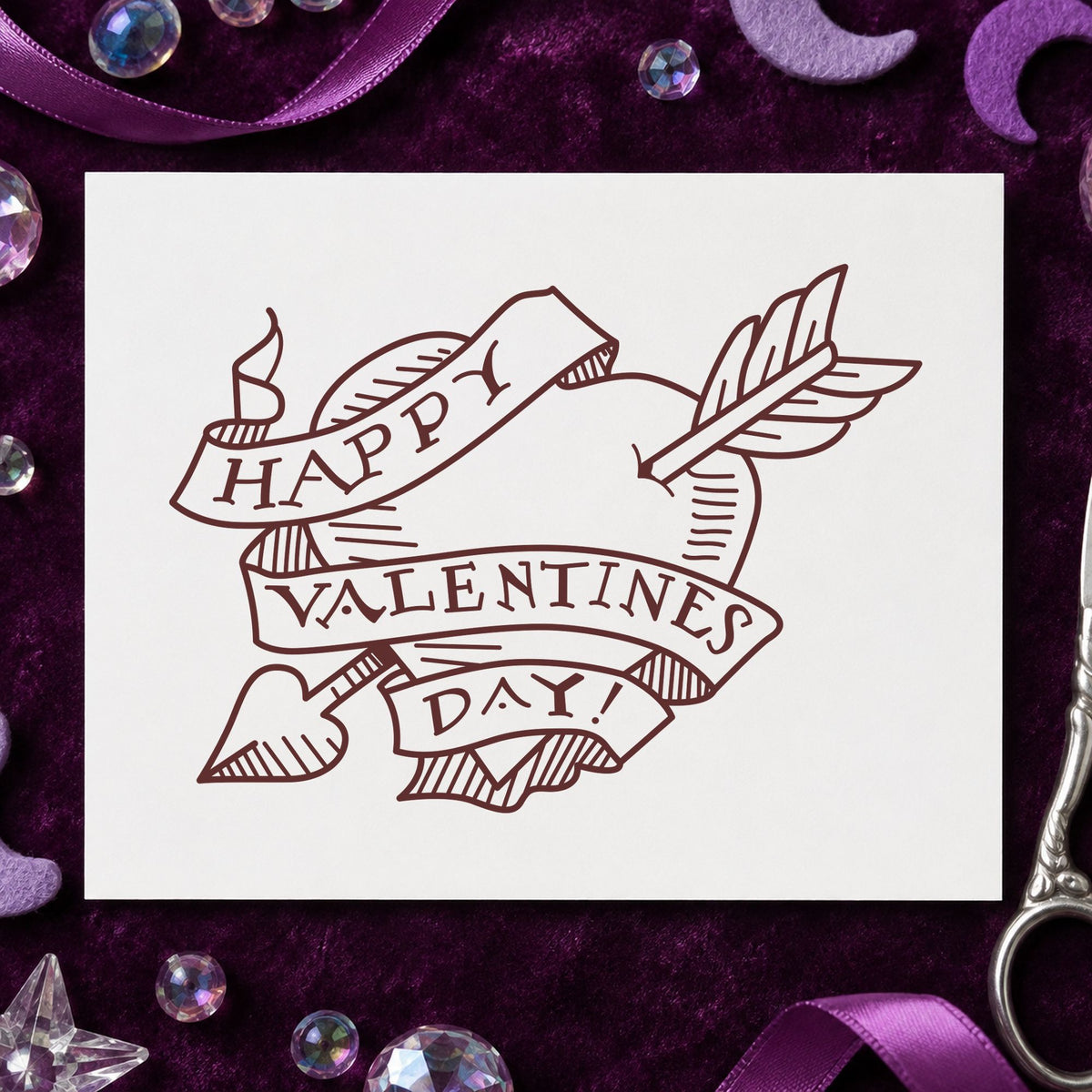 Valentine Heart with Arrow Rubber Stamp impression in brown ink on white paper in a styled craft setting.