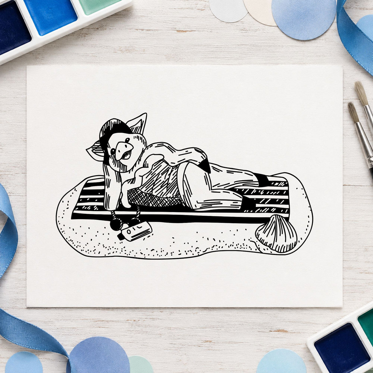 Pig on Beach Blanket Rubber Stamp impression in black ink on white paper in a styled craft setting.
