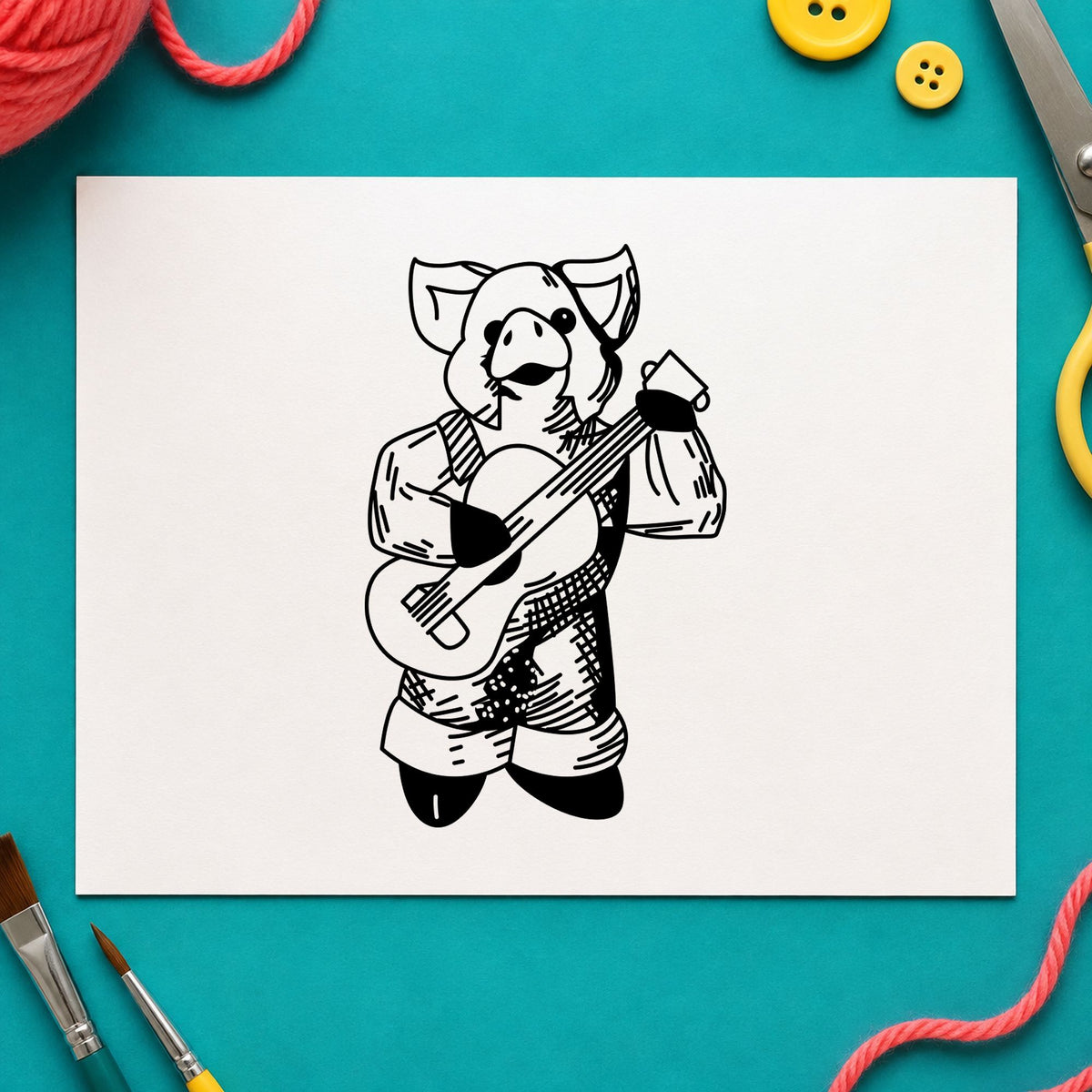 Banjo Playing Pig Rubber Stamp impression in black ink on white paper in a styled craft setting.