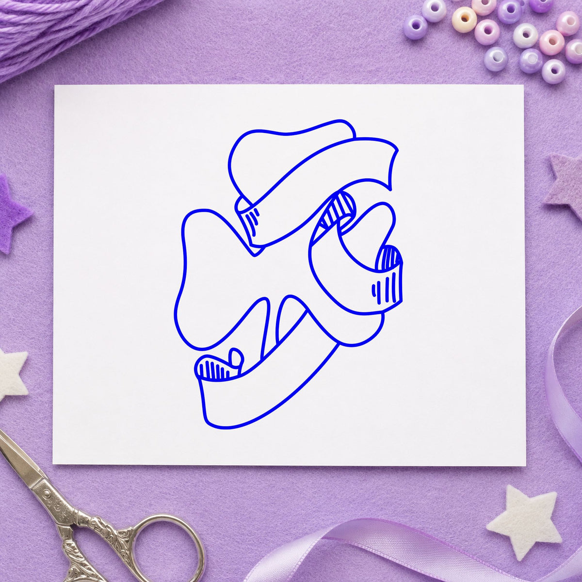 Blue st patrick's day craft stamp impression featuring the shamrock with leprechaun hat design on white paper.