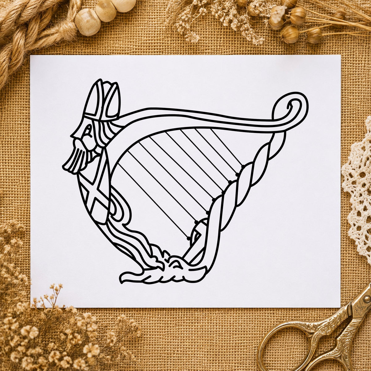Decorative Harp Rubber Stamp impression in black ink on white paper in a styled craft setting.