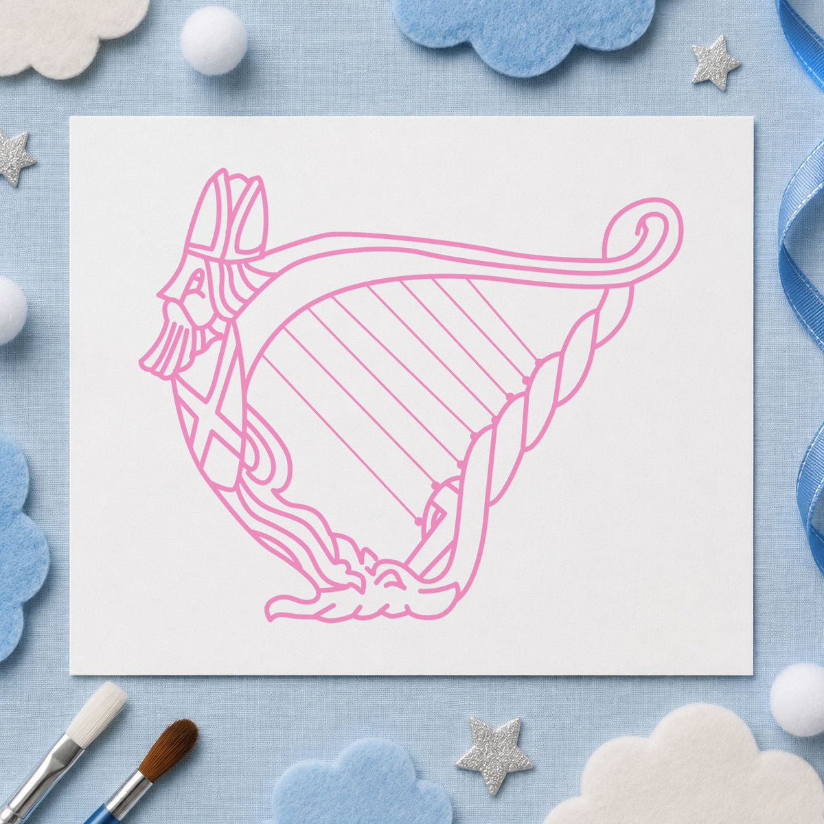 Decorative Harp Rubber Stamp impression in pink ink on white paper in a styled craft setting.