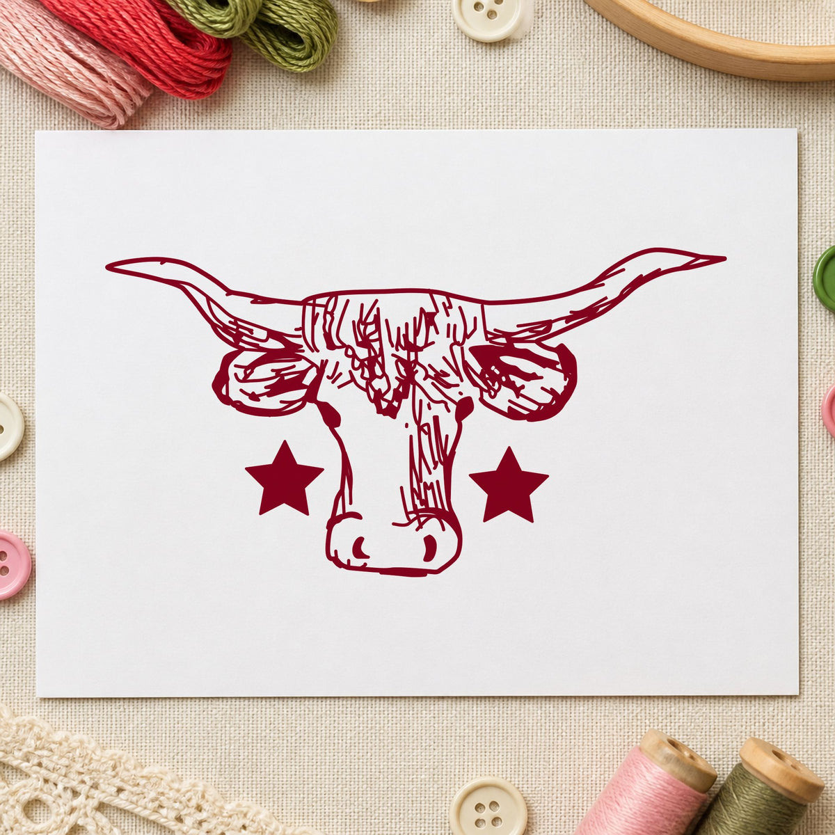 Lone Star Longhorn Bull Rubber Stamp impression in burgundy ink on white paper in a styled craft setting.