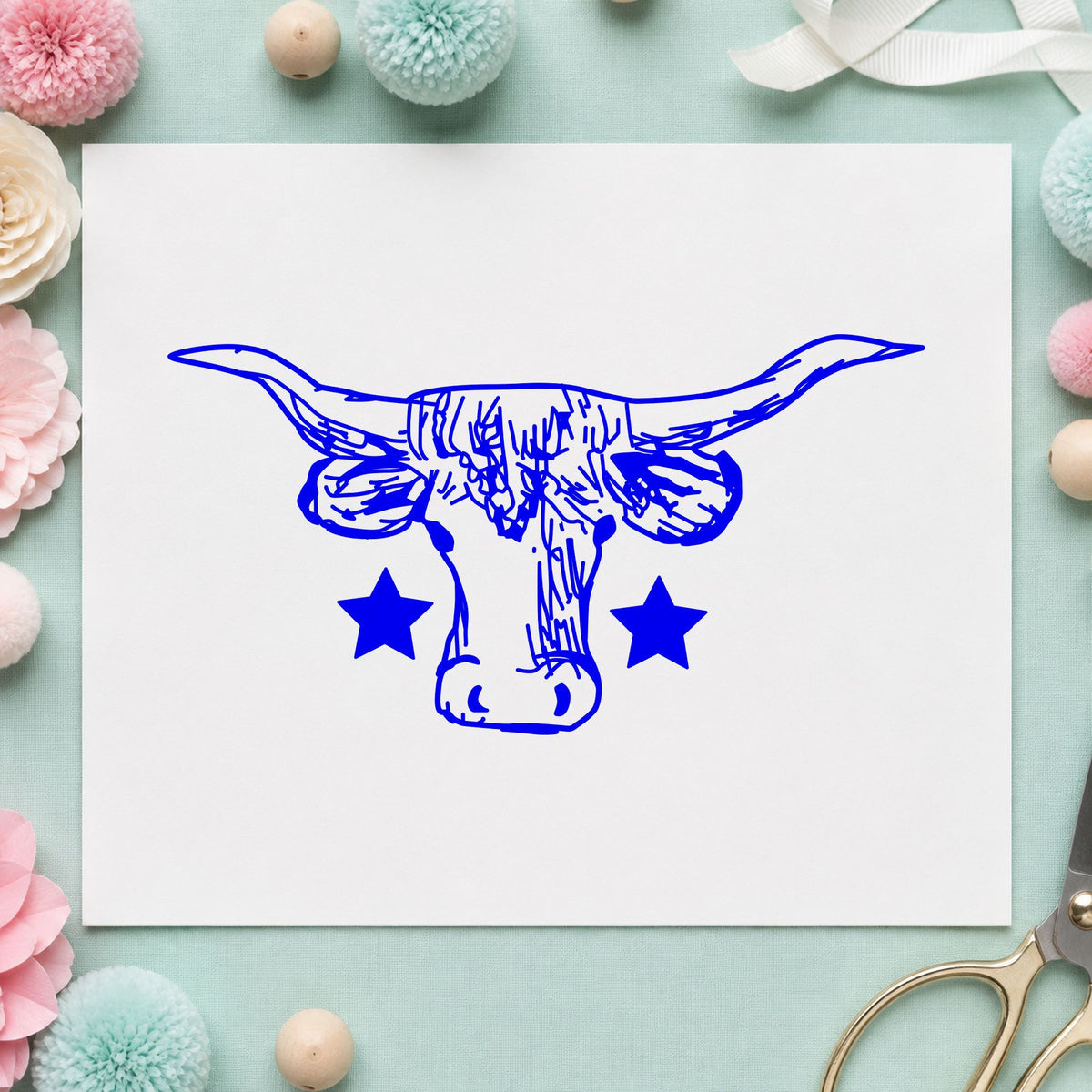 Lone Star Longhorn Bull Rubber Stamp impression in blue ink on white paper in a styled craft setting.