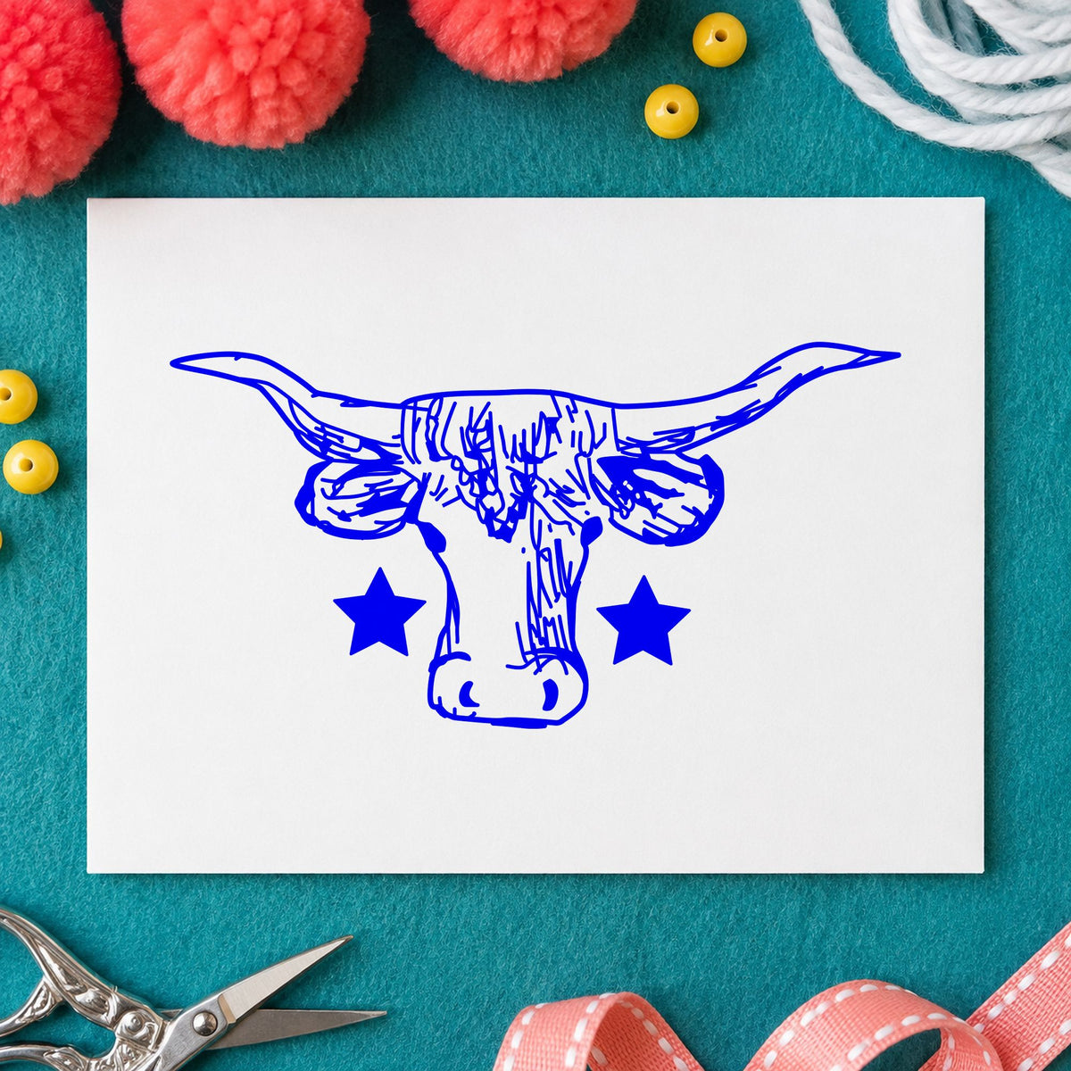 Blue western craft stamp impression featuring the lone star longhorn bull design on white paper.