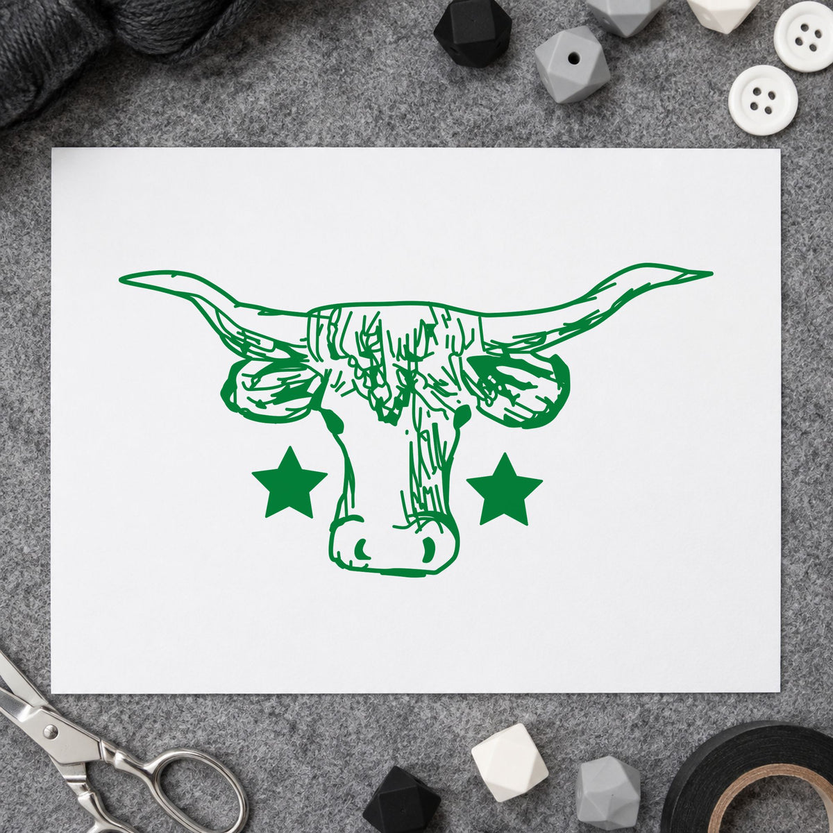 Lone Star Longhorn Bull Rubber Stamp impression in green ink on white paper in a styled craft setting.