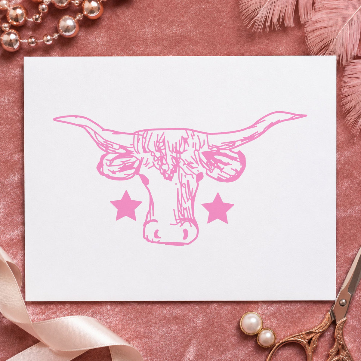 Lone Star Longhorn Bull Rubber Stamp impression in pink ink on white paper in a styled craft setting.