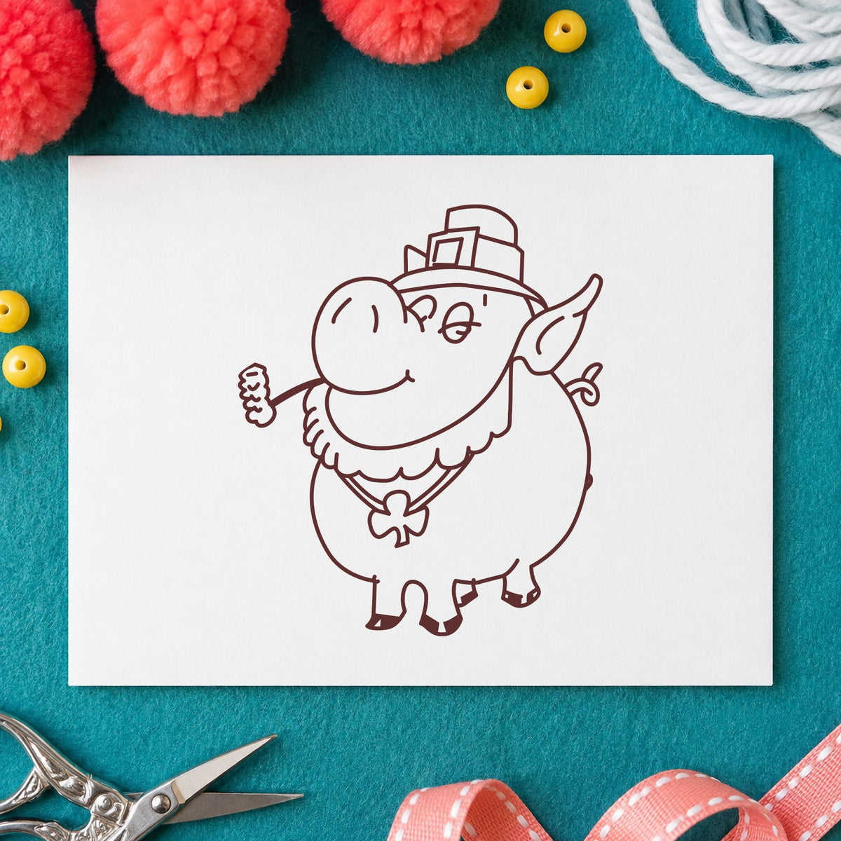 Irish Pig with Shamrock Rubber Stamp impression in brown ink on white paper in a styled craft setting.