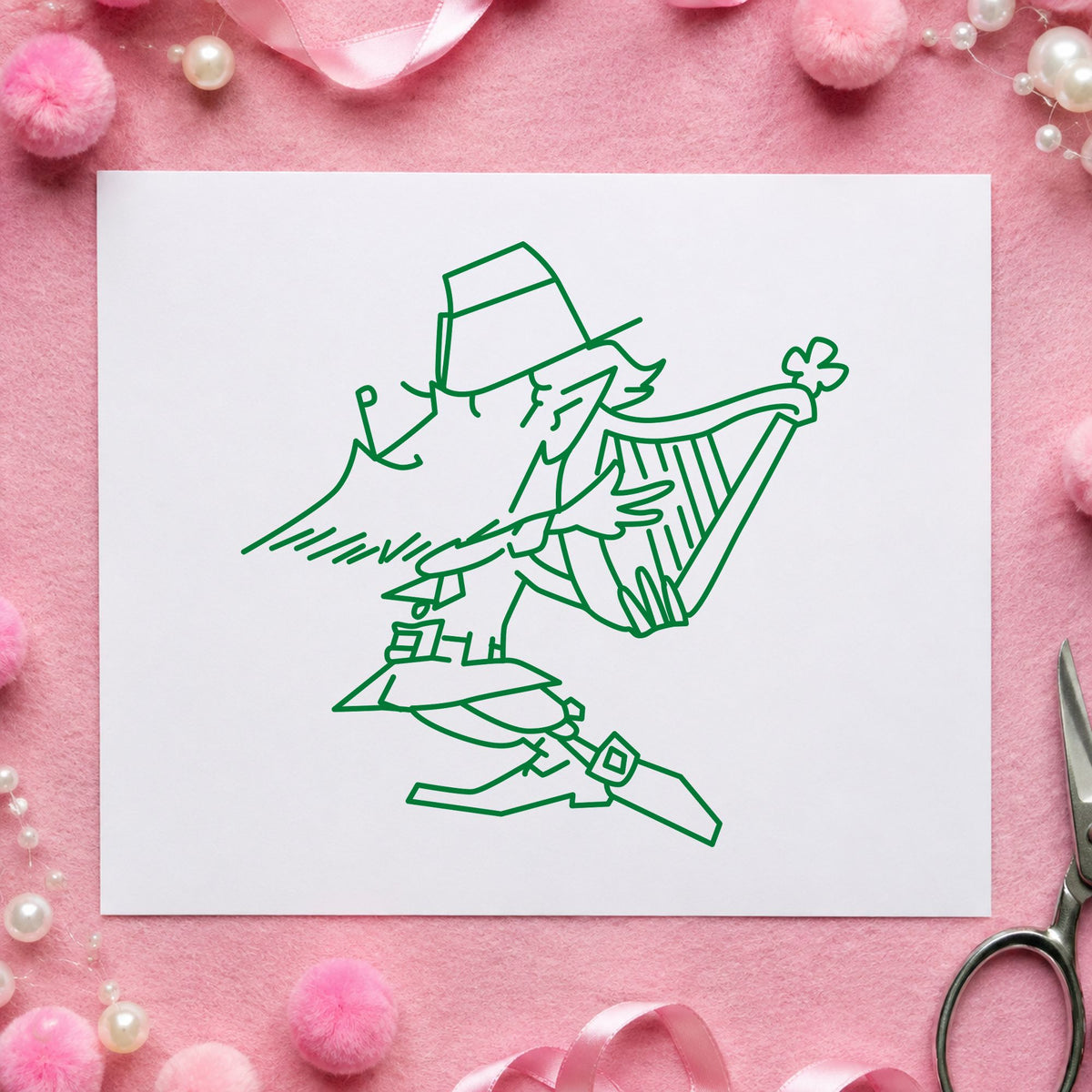 Leprechaun Playing Harp Rubber Stamp impression in green ink on white paper in a styled craft setting.