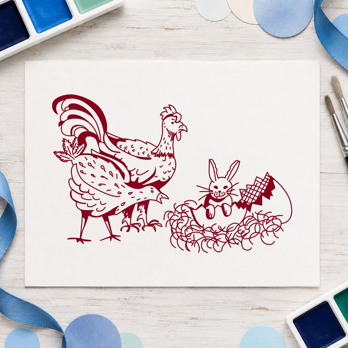 Chickens and Bunny in Easter Egg Rubber Stamp impression in burgundy ink on white paper in a styled craft setting.