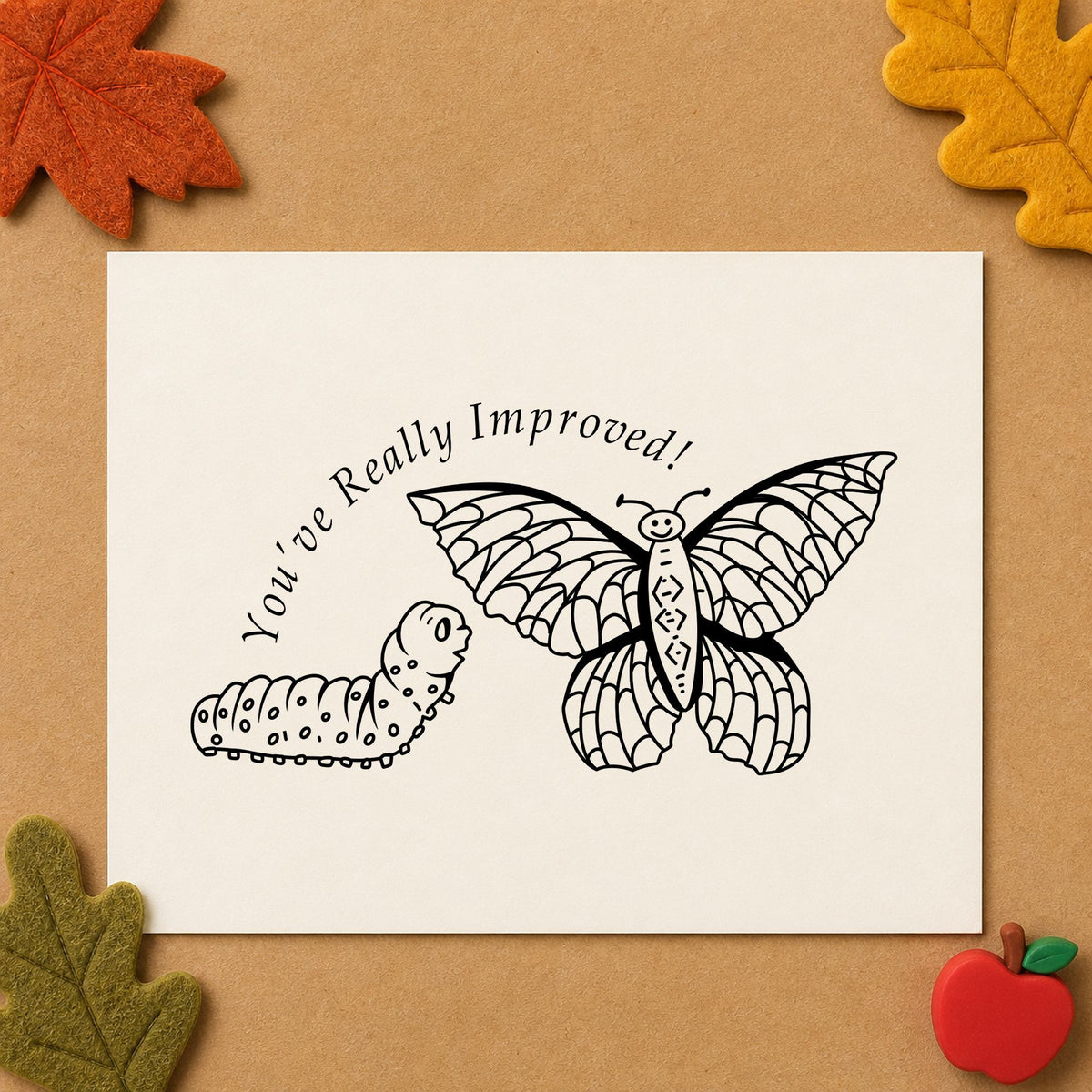 Youve Really Improved Butterfly and Caterpillar Rubber Stamp impression in black ink on white paper in a styled craft setting.