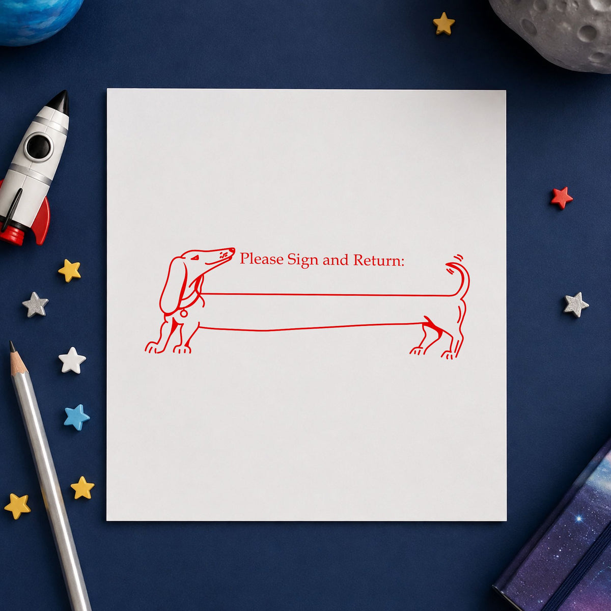 Blank Award Ribbon Rubber Stamp impression in red ink on white paper in a styled craft setting.