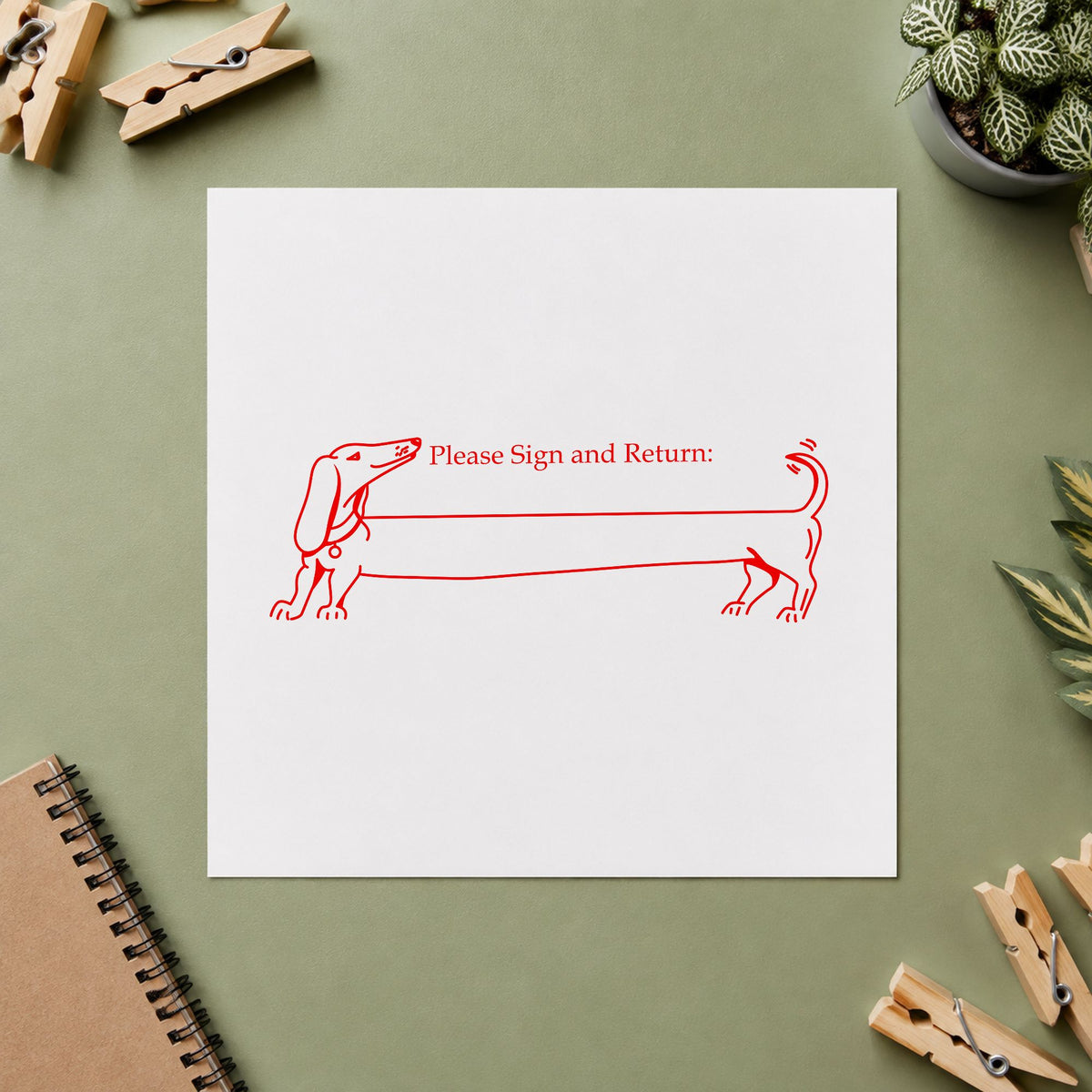 Please Sign and Return Dog Rubber Stamp impression in red ink on white paper in a styled craft setting.