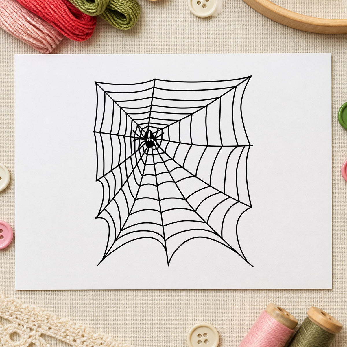 Spider and Web Halloween Rubber Stamp impression in black ink on white paper in a styled craft setting.