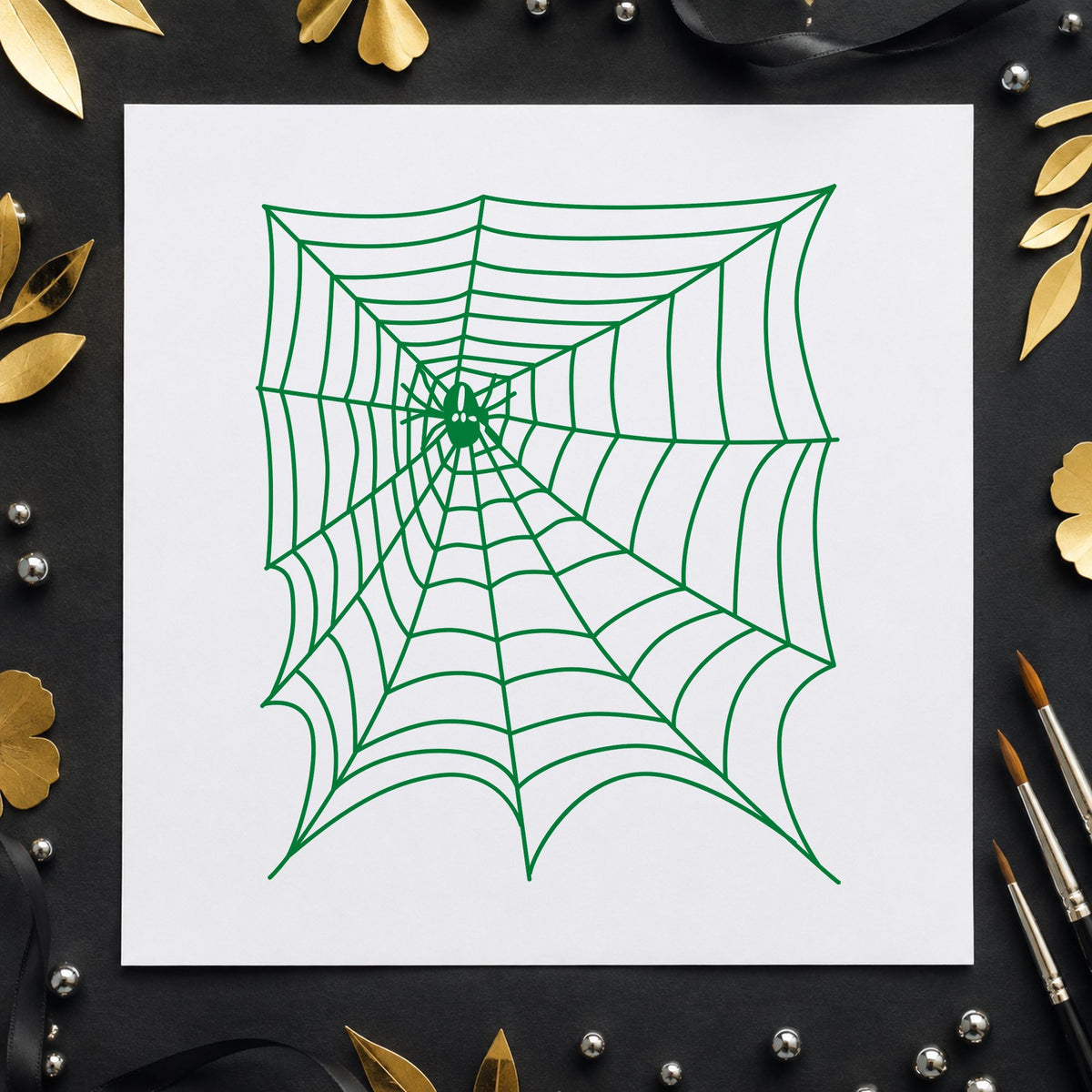 Spider and Web Halloween Rubber Stamp impression in green ink on white paper in a styled craft setting.