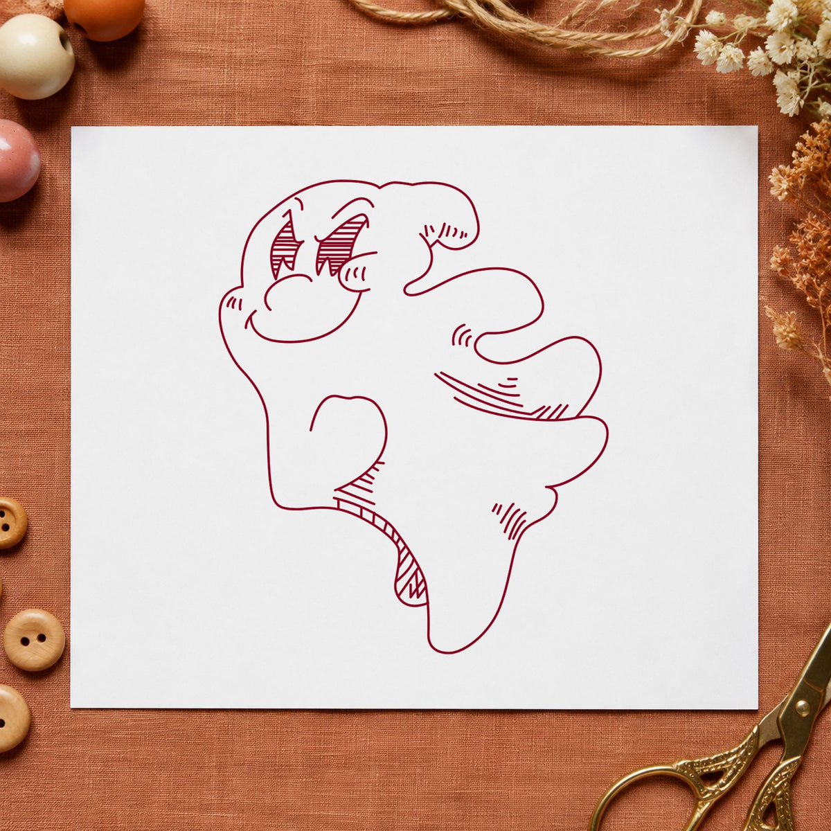 Friendly Smiling Ghost Rubber Stamp impression in burgundy ink on white paper in a styled craft setting.