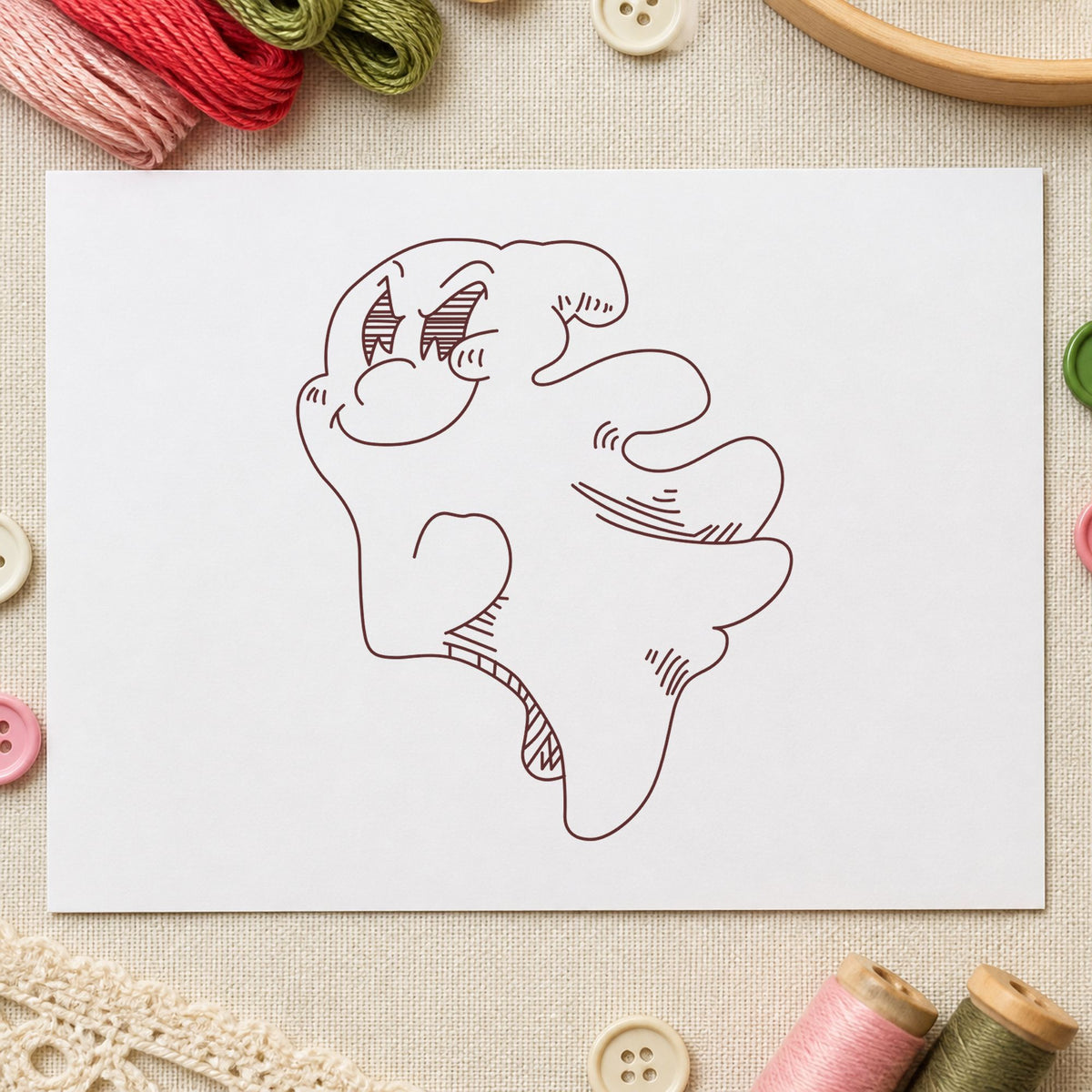 Friendly Smiling Ghost Rubber Stamp impression in brown ink on white paper in a styled craft setting.