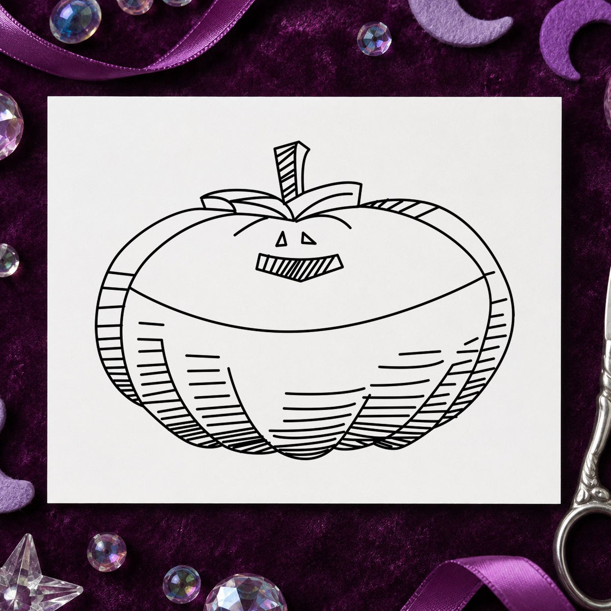 Smiling Jacko Lantern Rubber Stamp impression in black ink on white paper in a styled craft setting.