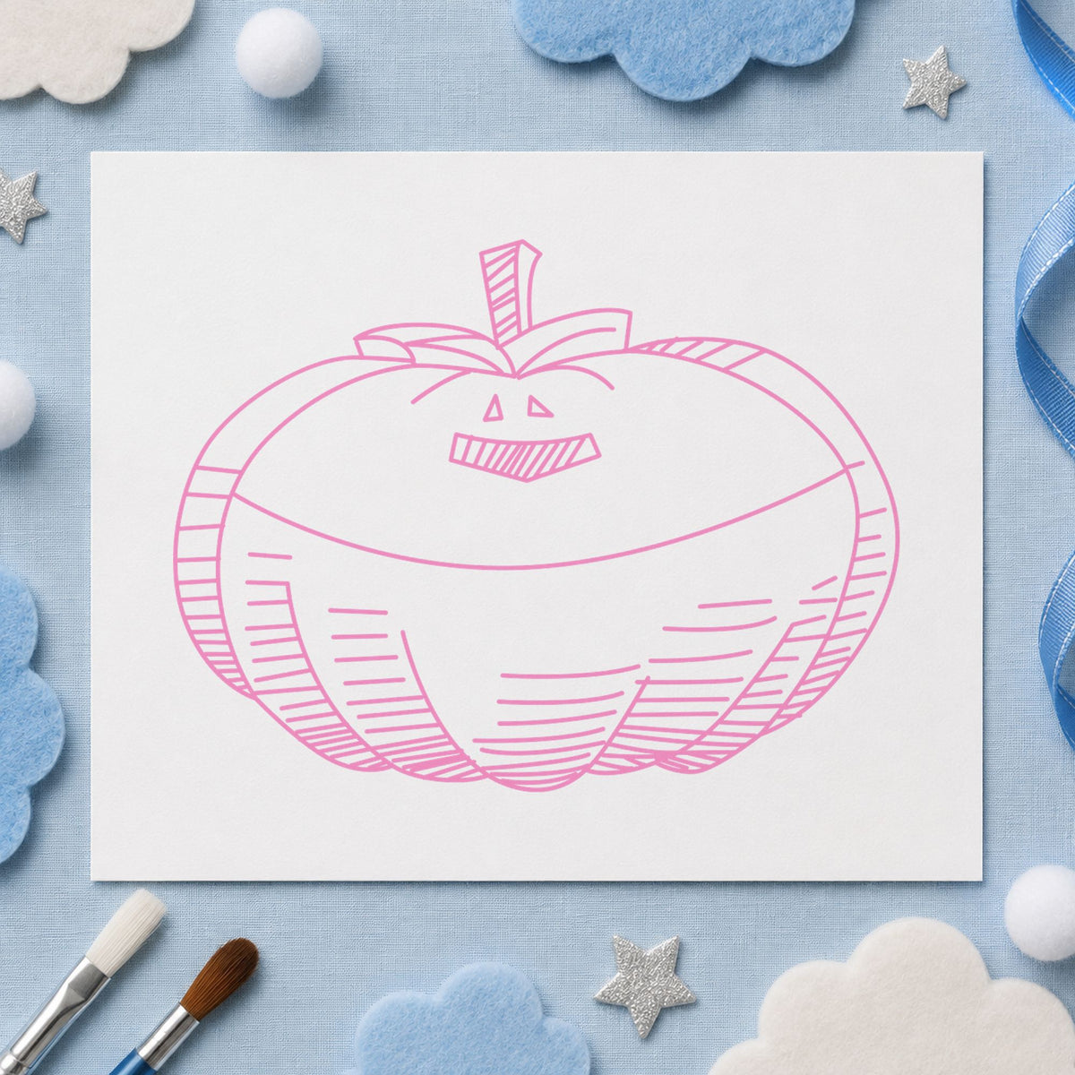 Smiling Jacko Lantern Rubber Stamp impression in pink ink on white paper in a styled craft setting.
