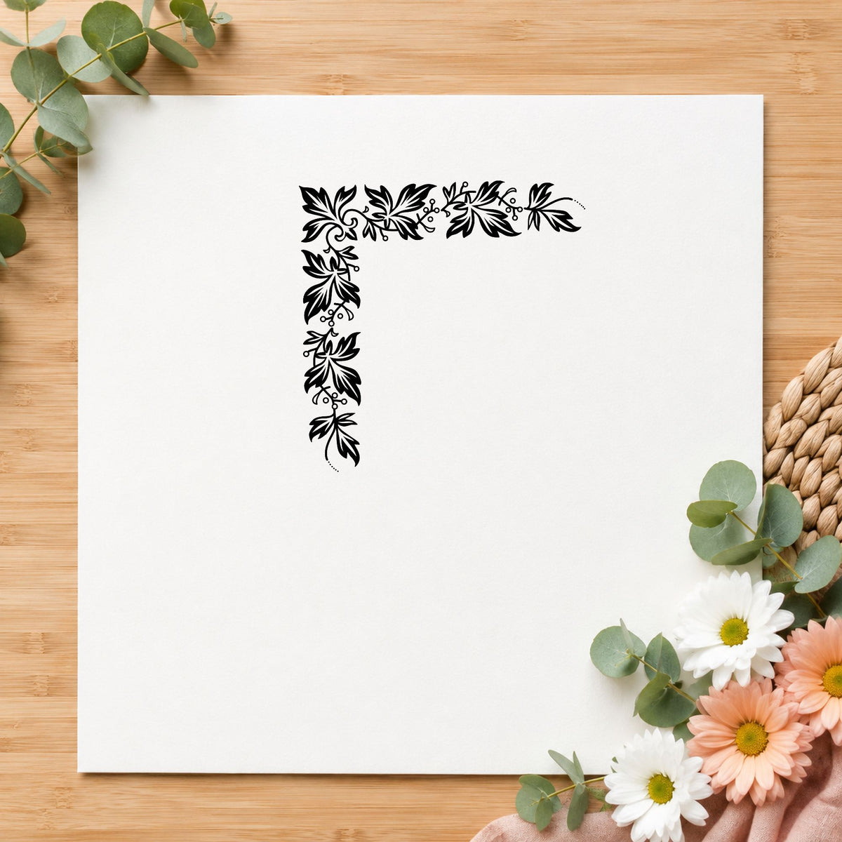 Semi Solid Leaf Corner Rubber Stamp impression in black ink on white paper in a styled craft setting.