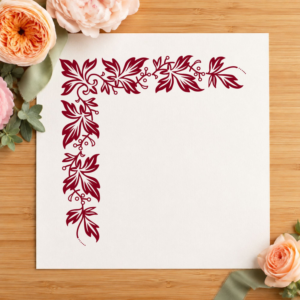 Semi Solid Leaf Corner Rubber Stamp impression in burgundy ink on white paper in a styled craft setting.