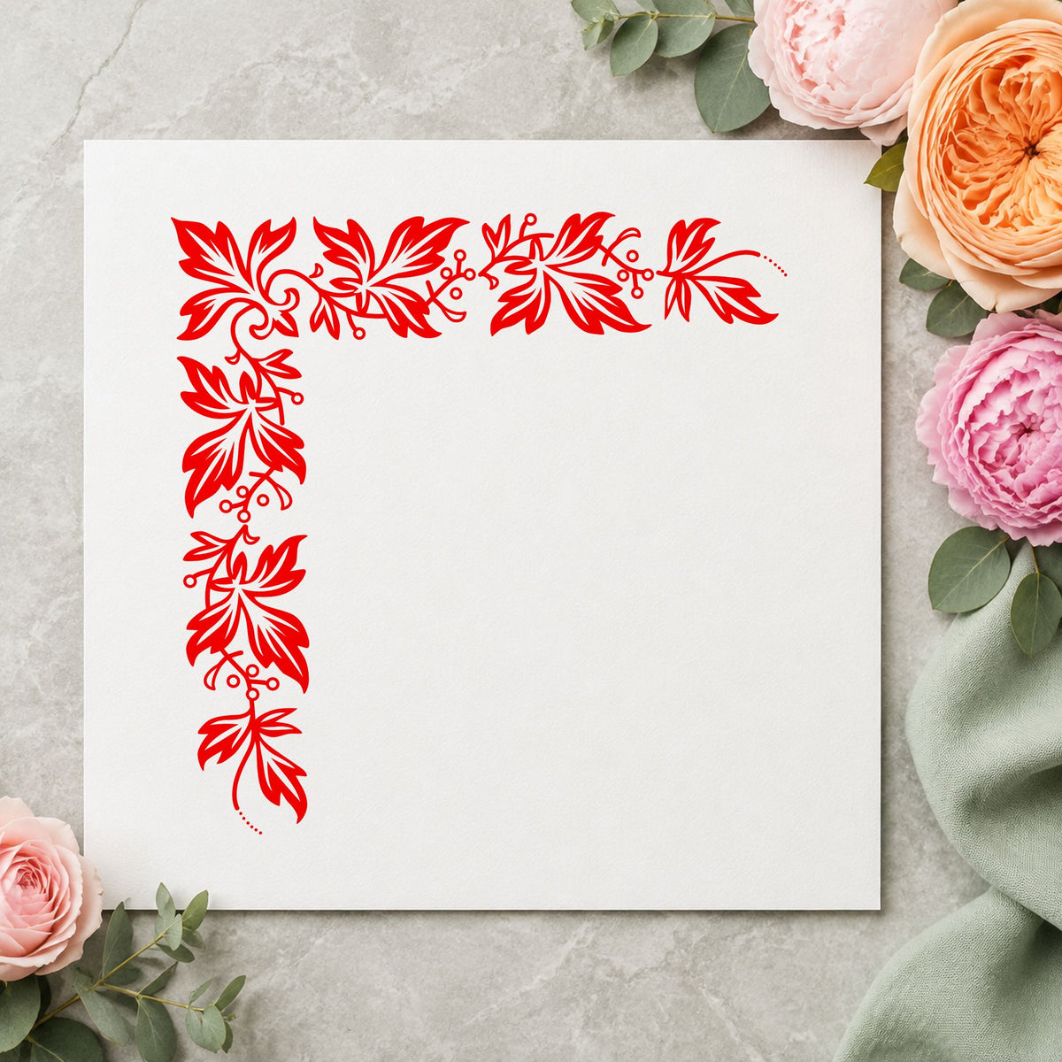 Semi Solid Leaf Corner Rubber Stamp impression in red ink on white paper in a styled craft setting.