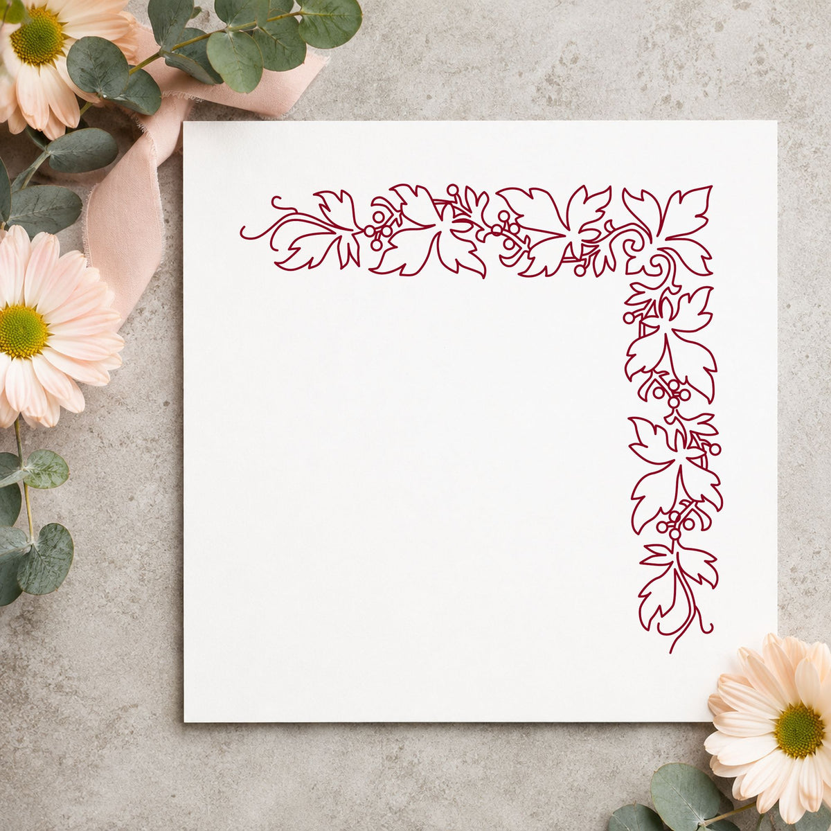 Open Leaf Corner Border Rubber Stamp impression in burgundy ink on white paper in a styled craft setting.