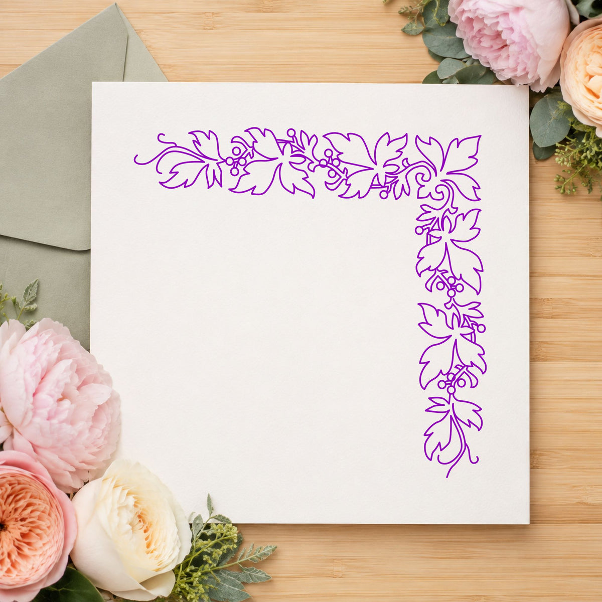 Open Leaf Corner Border Rubber Stamp impression in purple ink on white paper in a styled craft setting.