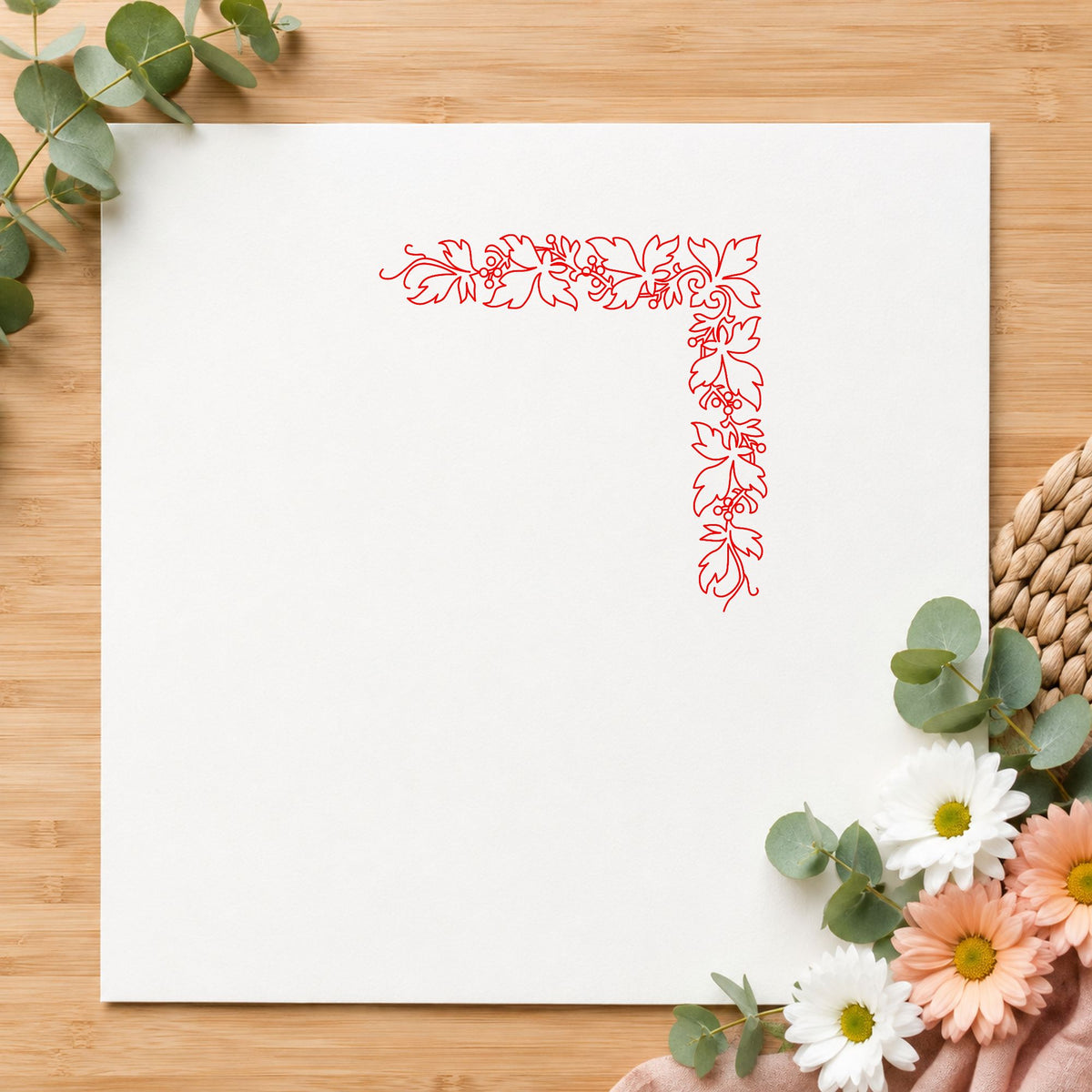 Open Leaf Corner Border Rubber Stamp impression in red ink on white paper in a styled craft setting.