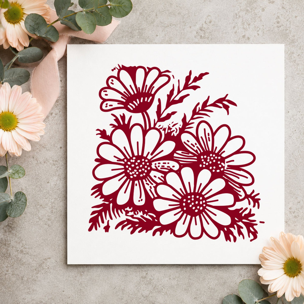 Four Daisy Blooms Rubber Stamp impression in burgundy ink on white paper in a styled craft setting.