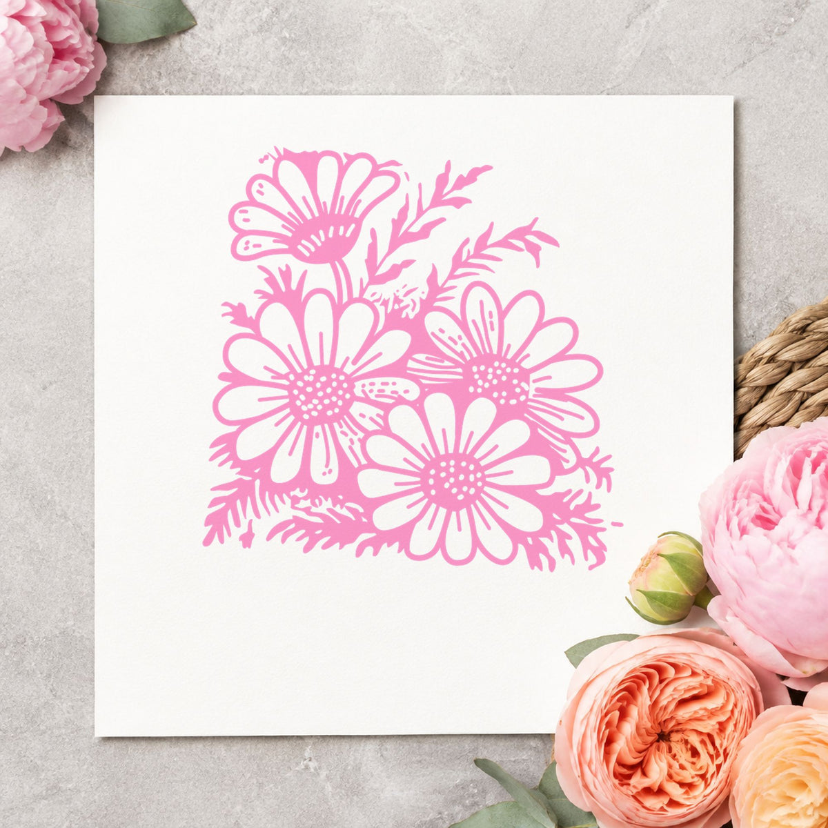 Four Daisy Blooms Rubber Stamp impression in pink ink on white paper in a styled craft setting.