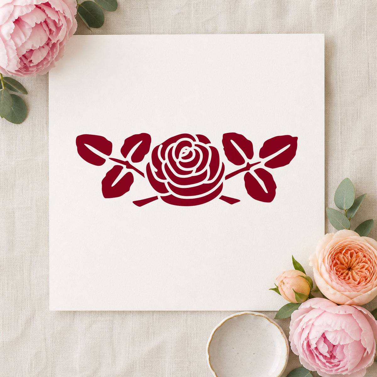 Rose Flower Rubber Stamp Large impression in burgundy ink on white paper in a styled craft setting.