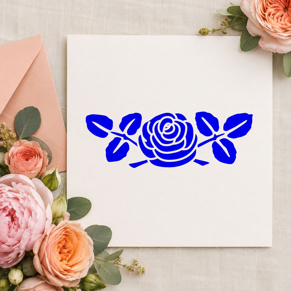 Blue floral craft stamp impression featuring the rose flower large design on white paper.
