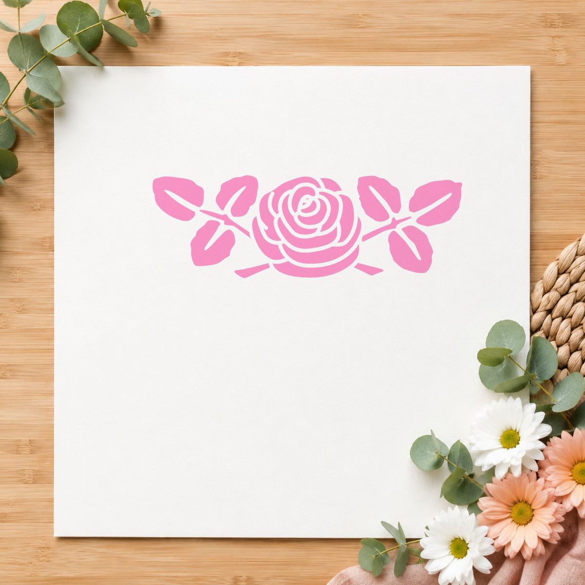Rose Flower Rubber Stamp Large impression in pink ink on white paper in a styled craft setting.