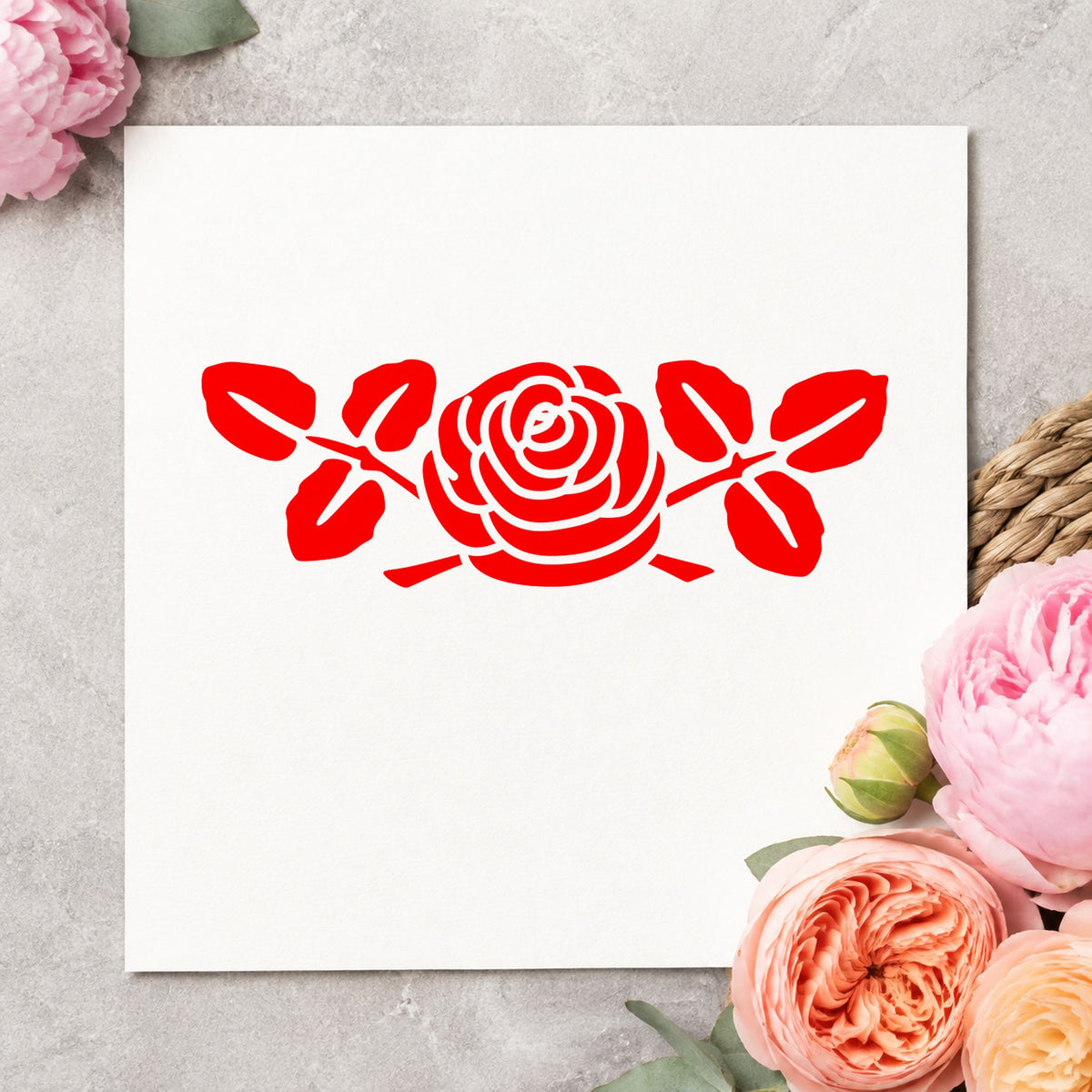 Rose with Leaves Rubber Stamp Small impression in red ink on white paper in a styled craft setting.