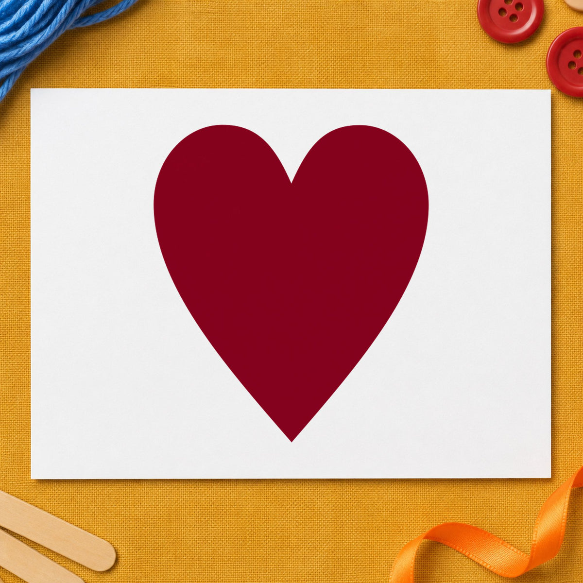 Playing Card Heart Rubber Stamp impression in burgundy ink on white paper in a styled craft setting.
