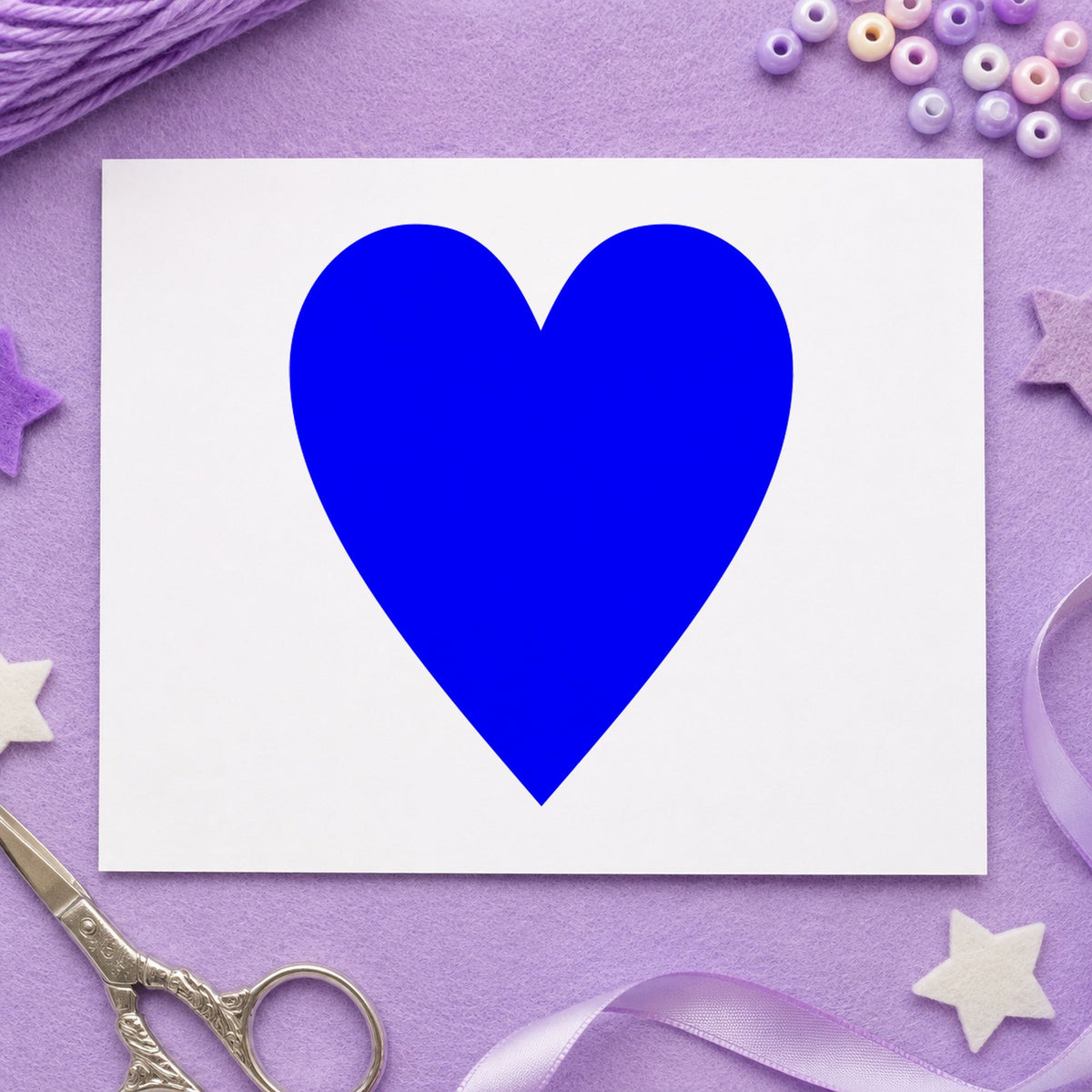 Playing Card Heart Rubber Stamp impression in blue ink on white paper in a styled craft setting.