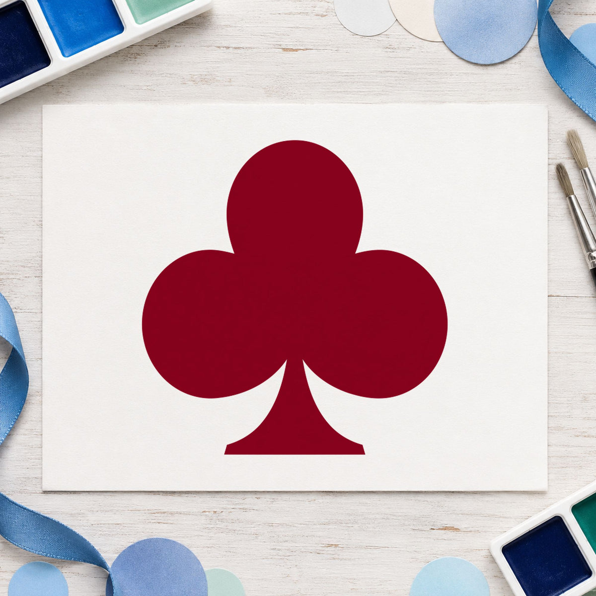 Playing Card Club Rubber Stamp impression in burgundy ink on white paper in a styled craft setting.