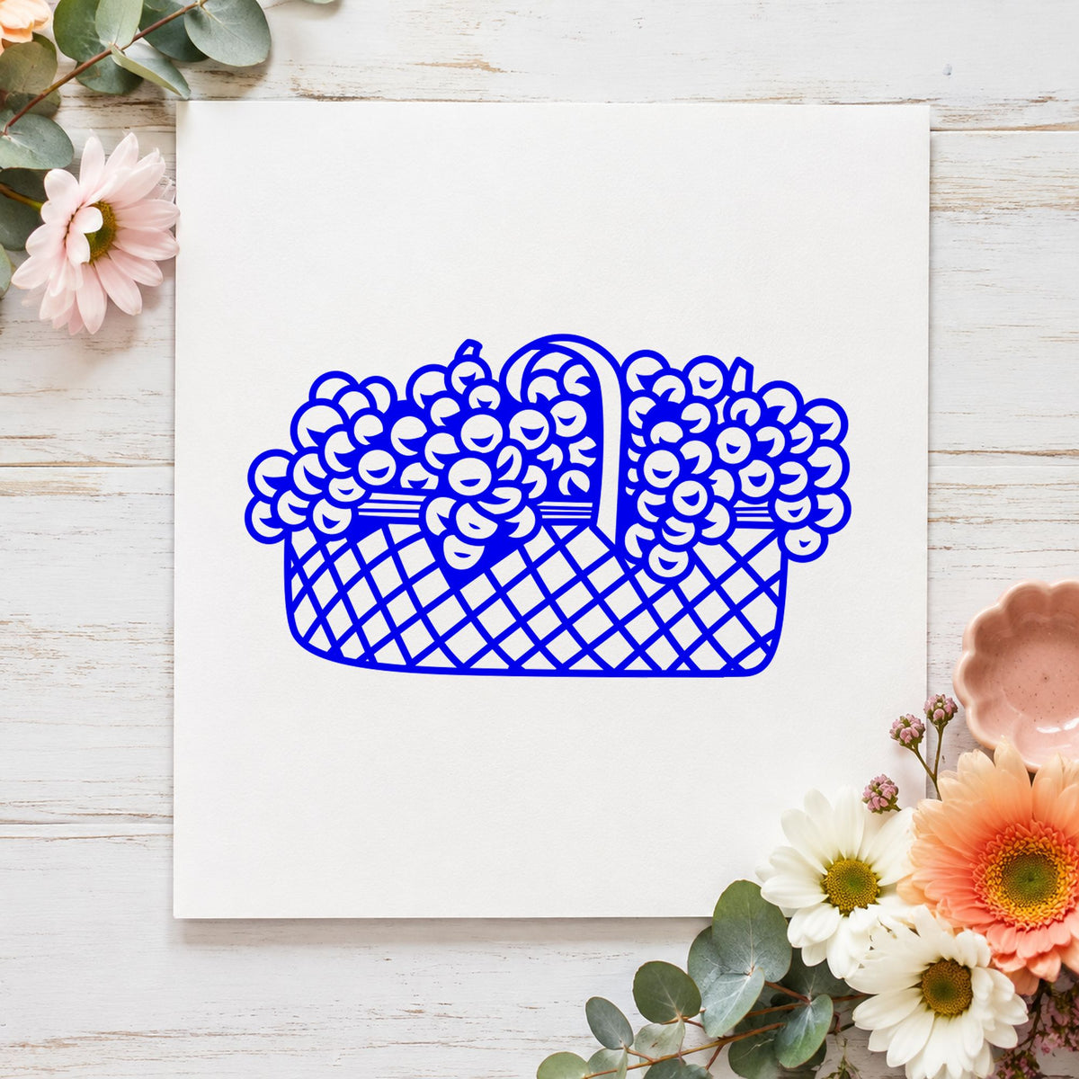 Blue botanical card making stamp impression featuring the basket of flowers large design on white paper.