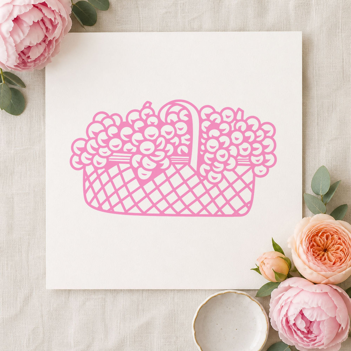 Basket of Flowers Rubber Stamp Large impression in pink ink on white paper in a styled craft setting.
