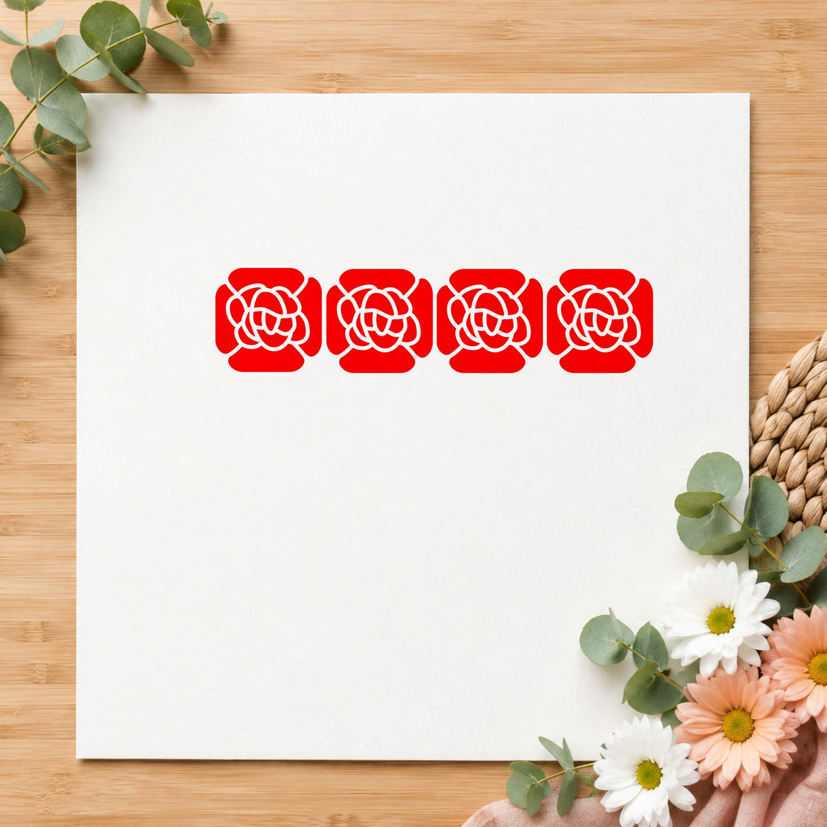 Four Solid Flowers Border Rubber Stamp impression in red ink on white paper in a styled craft setting.