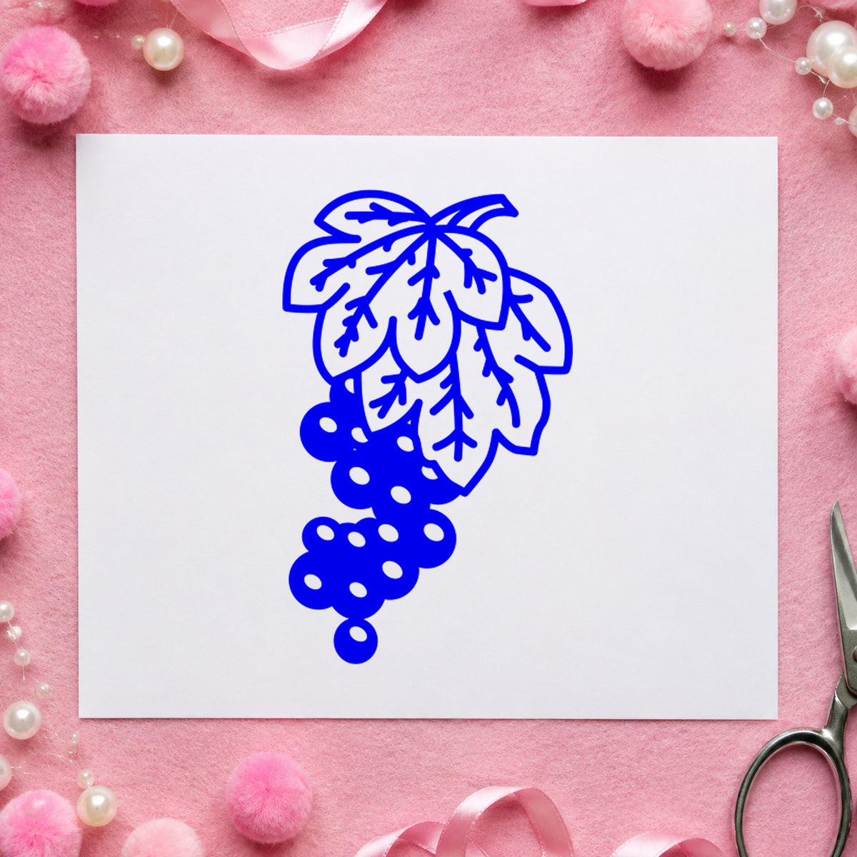Grape Bunch on Vine Rubber Stamp impression in blue ink on white paper in a styled craft setting.