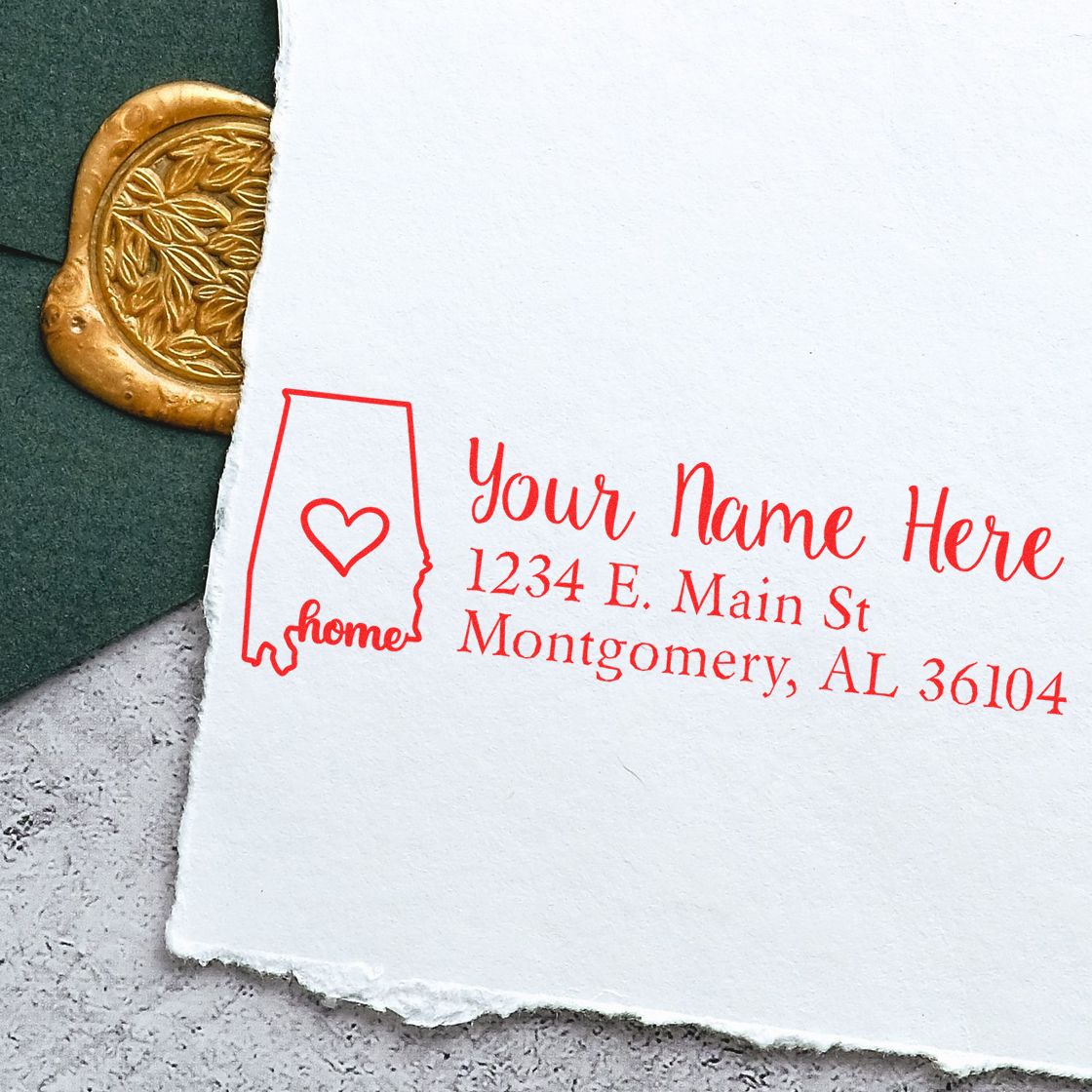 Custom return address rubber stamp with Alabama home logo, personalized name, and address in red ink.