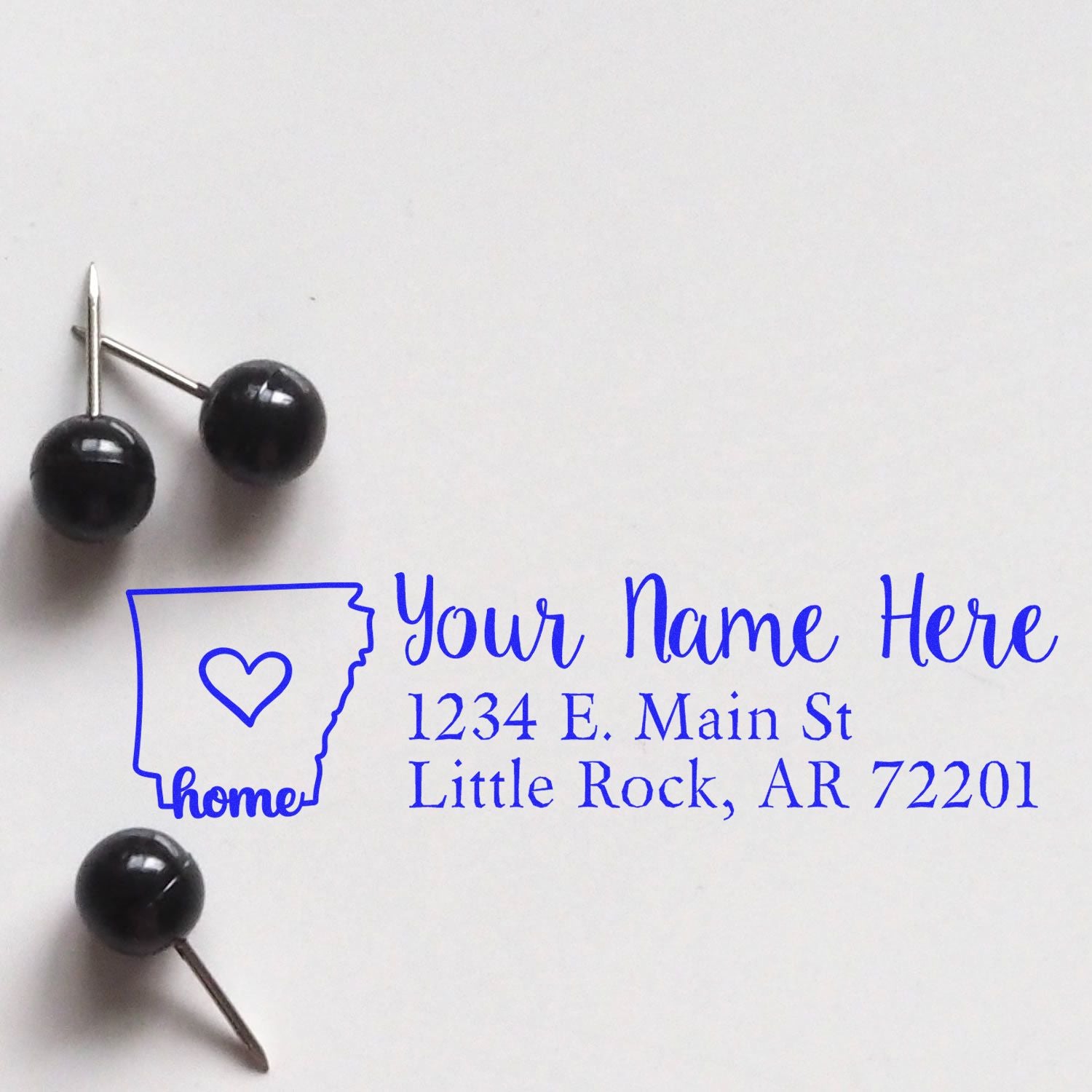 Personalized rubber address stamp with home icon and return address for envelopes and mailings.