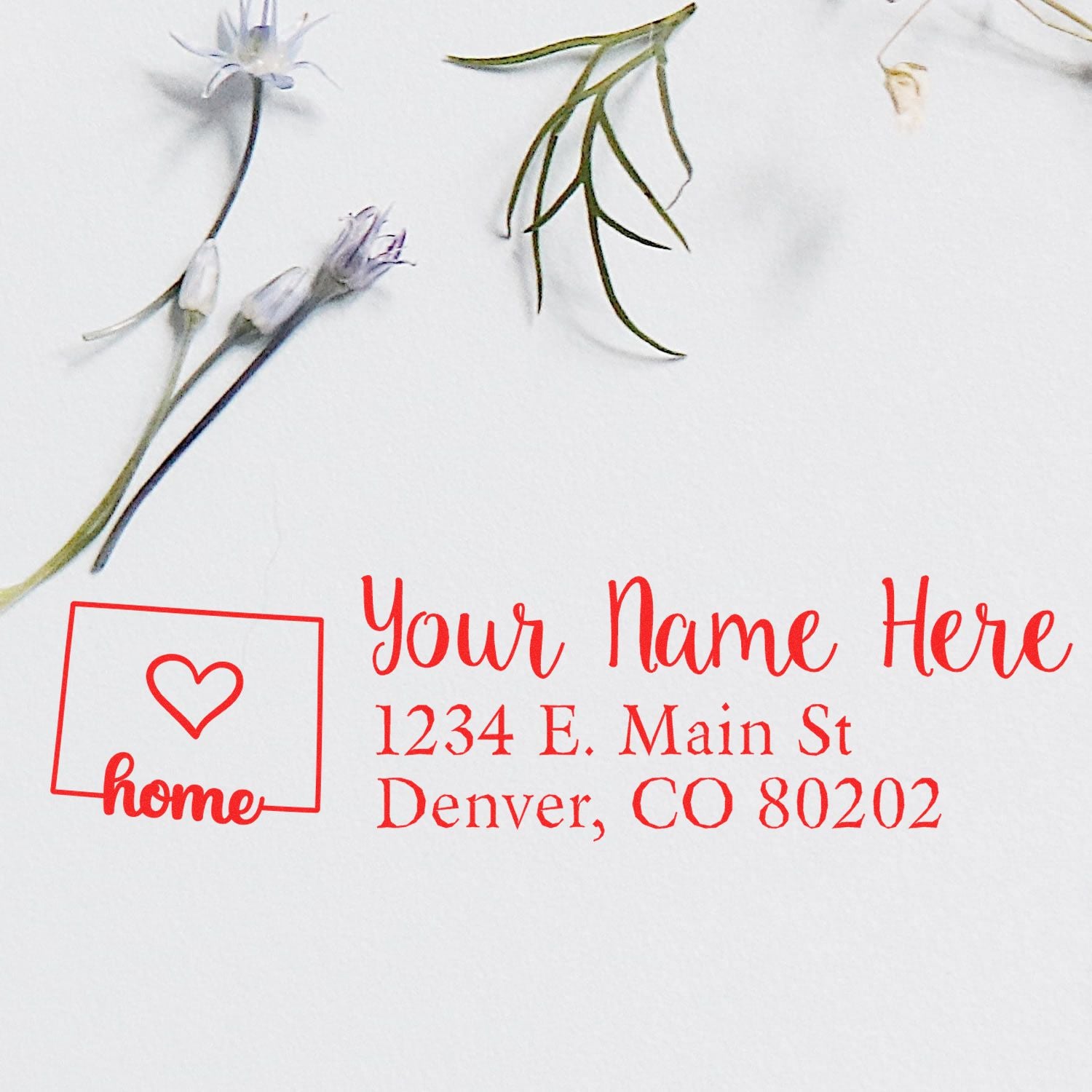 Custom return address rubber stamp with home icon, personalized name, and Denver, CO address in red ink.